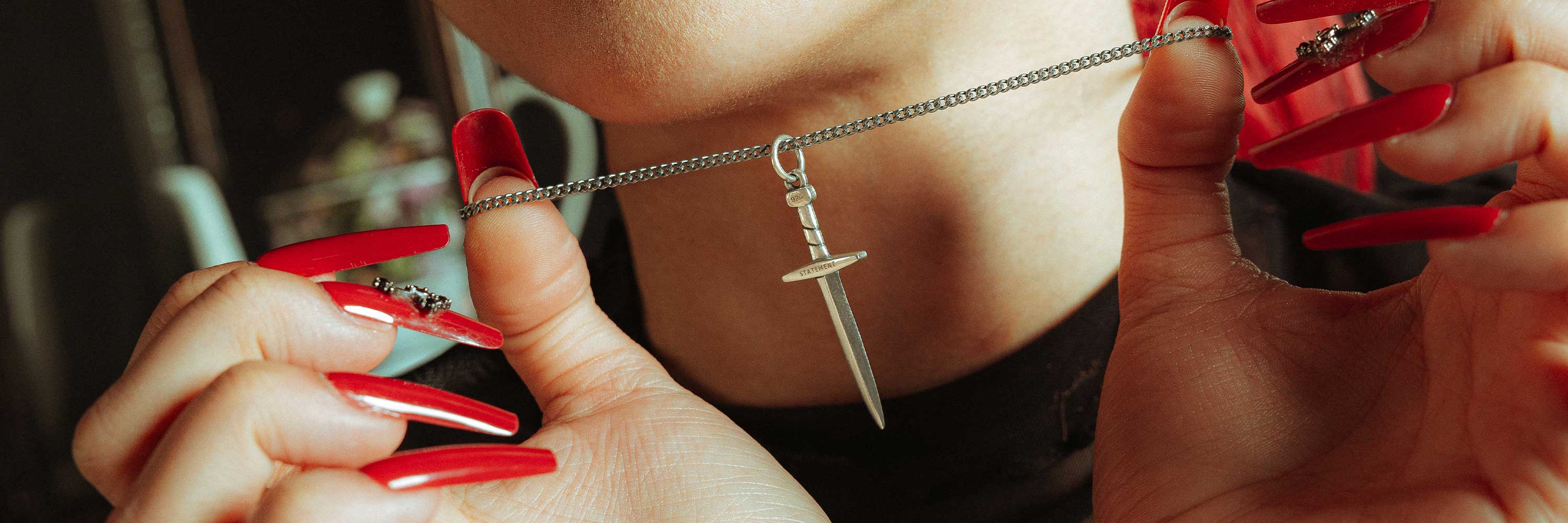 925 sterling silver dagger pendant on womens neck by statement