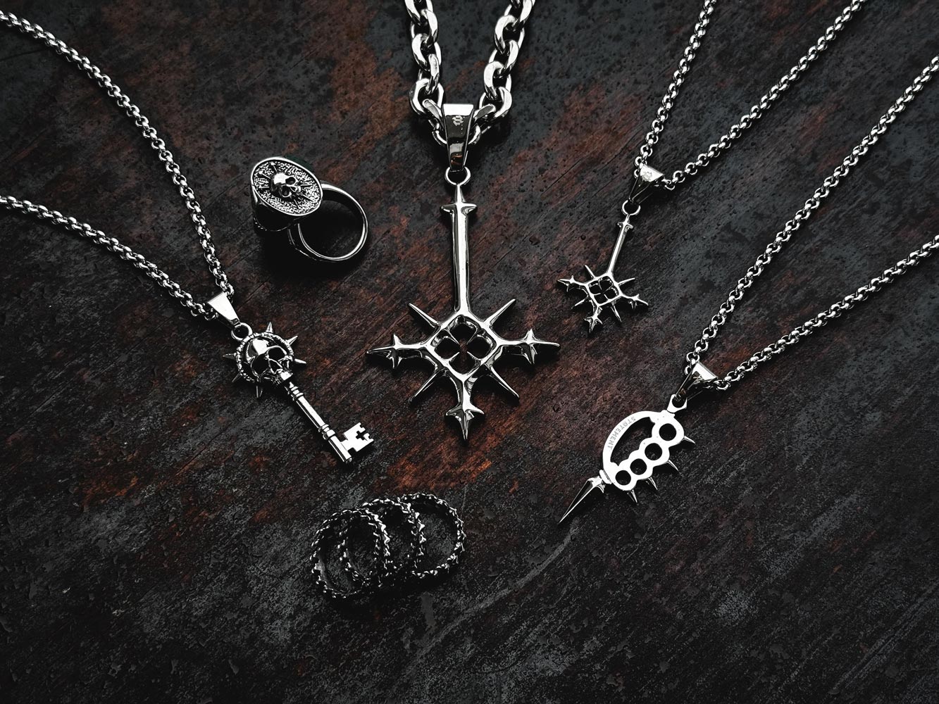 2024 design competition jewelry pieces displayed on dark wood background