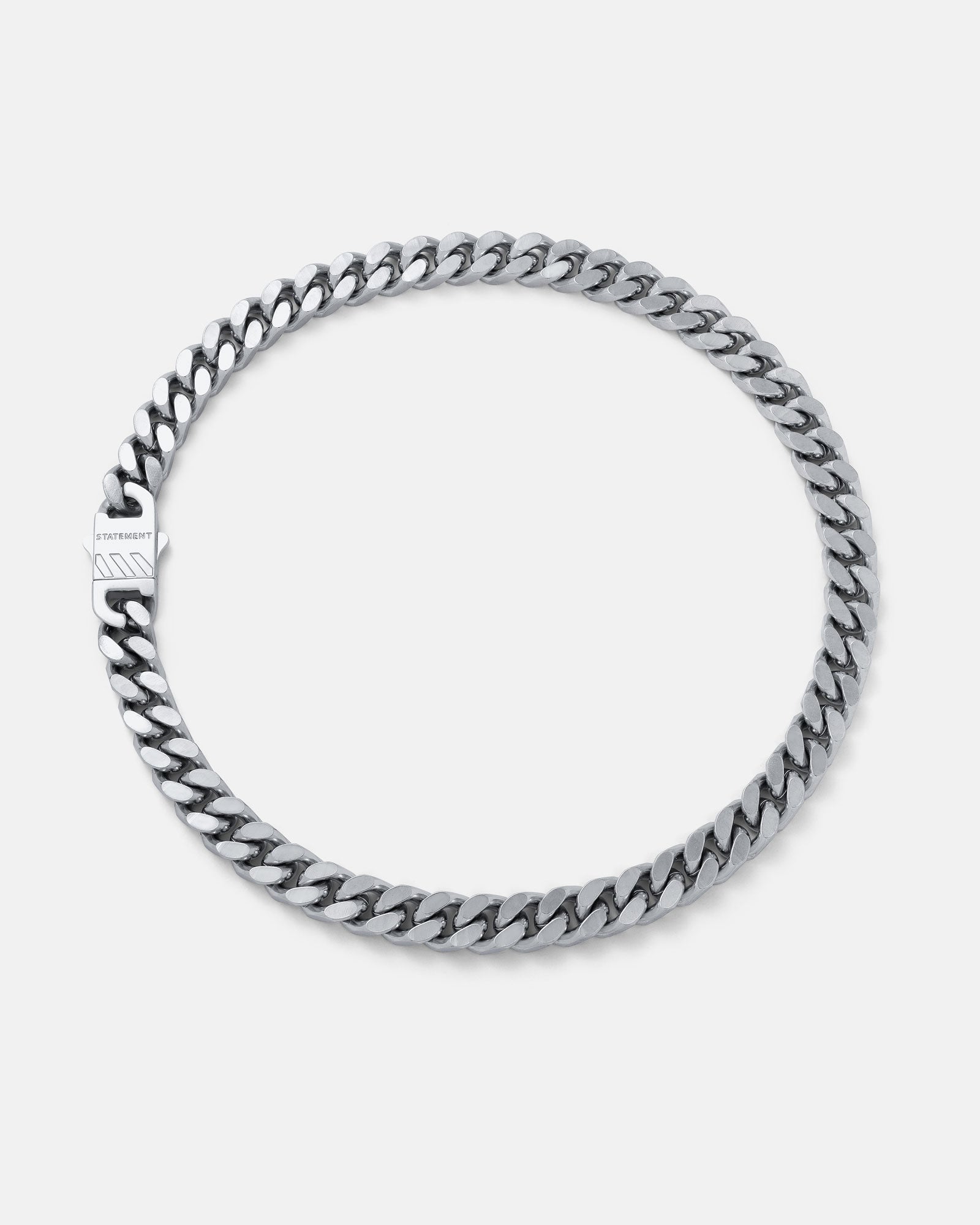 The 11mm Cuban Chain is a chunky necklace with a polished silver finish and a rectangular, logo-engraved clasp, displayed on a white background for a bold punk style statement.