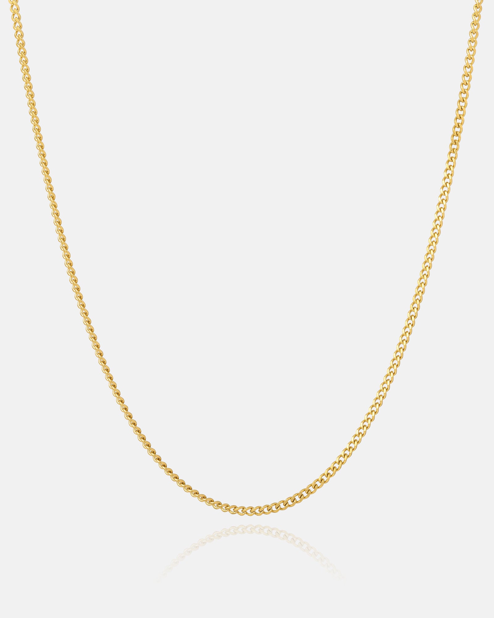 Thin gold cuban necklace on white