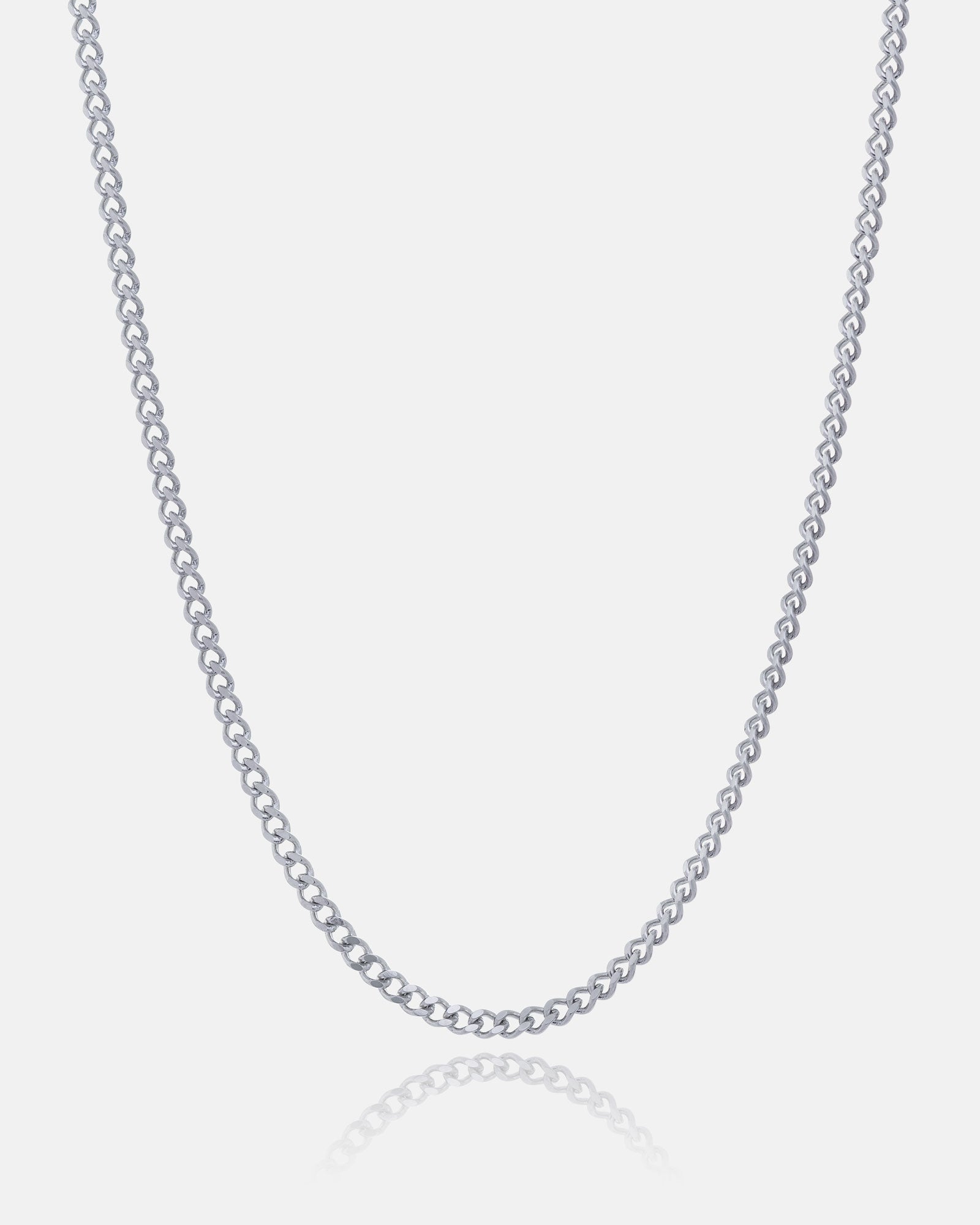 The 2.3mm Curb Chain is a simple, thin necklace with small, evenly spaced links for a classic, refined look. Displayed on a white background, the chain forms a gentle curve at the bottom.