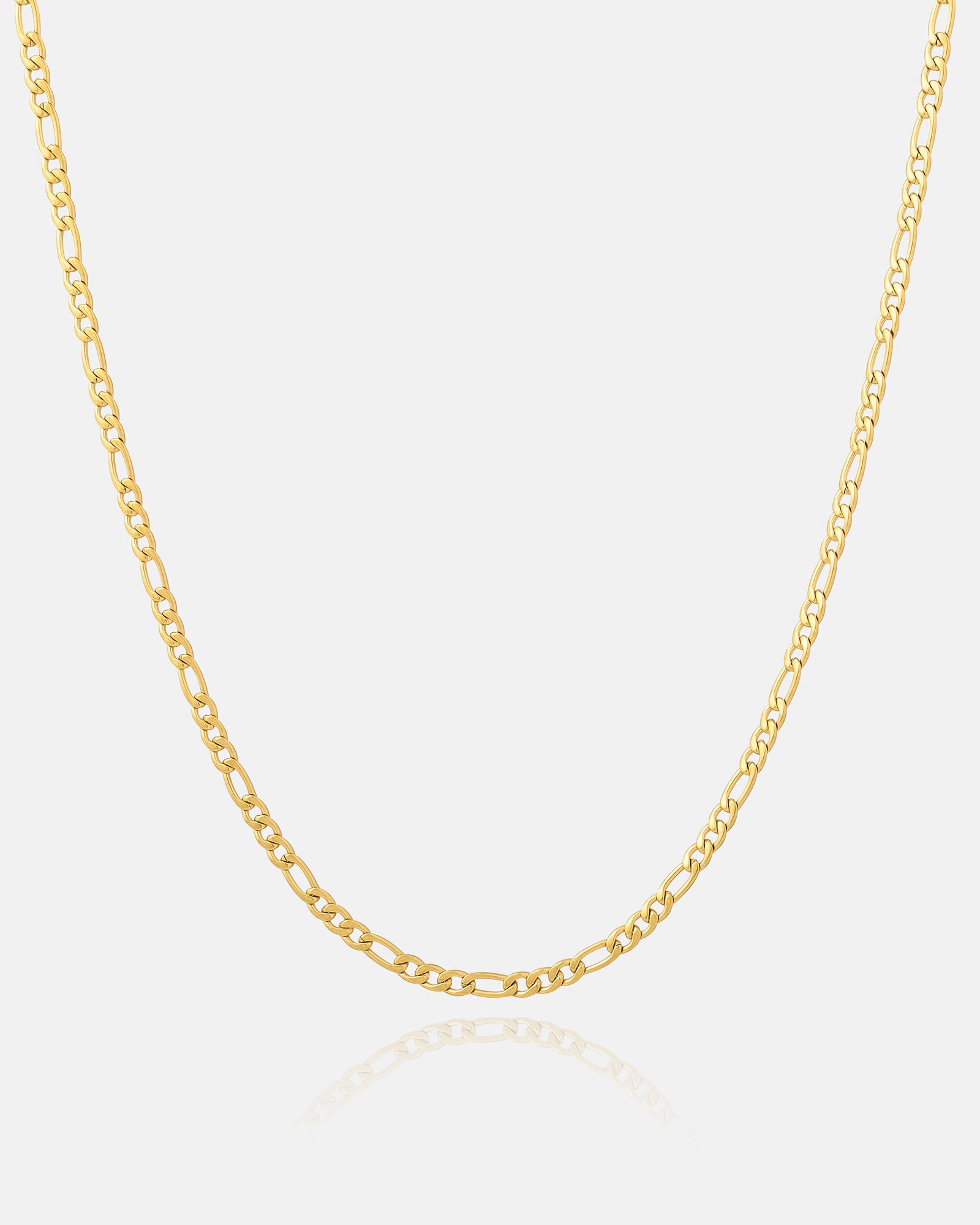 The 2.9mm Figaro Chain (Gold) is showcased on a white background, its slender gold links forming a gentle curve with a subtle reflection underneath.