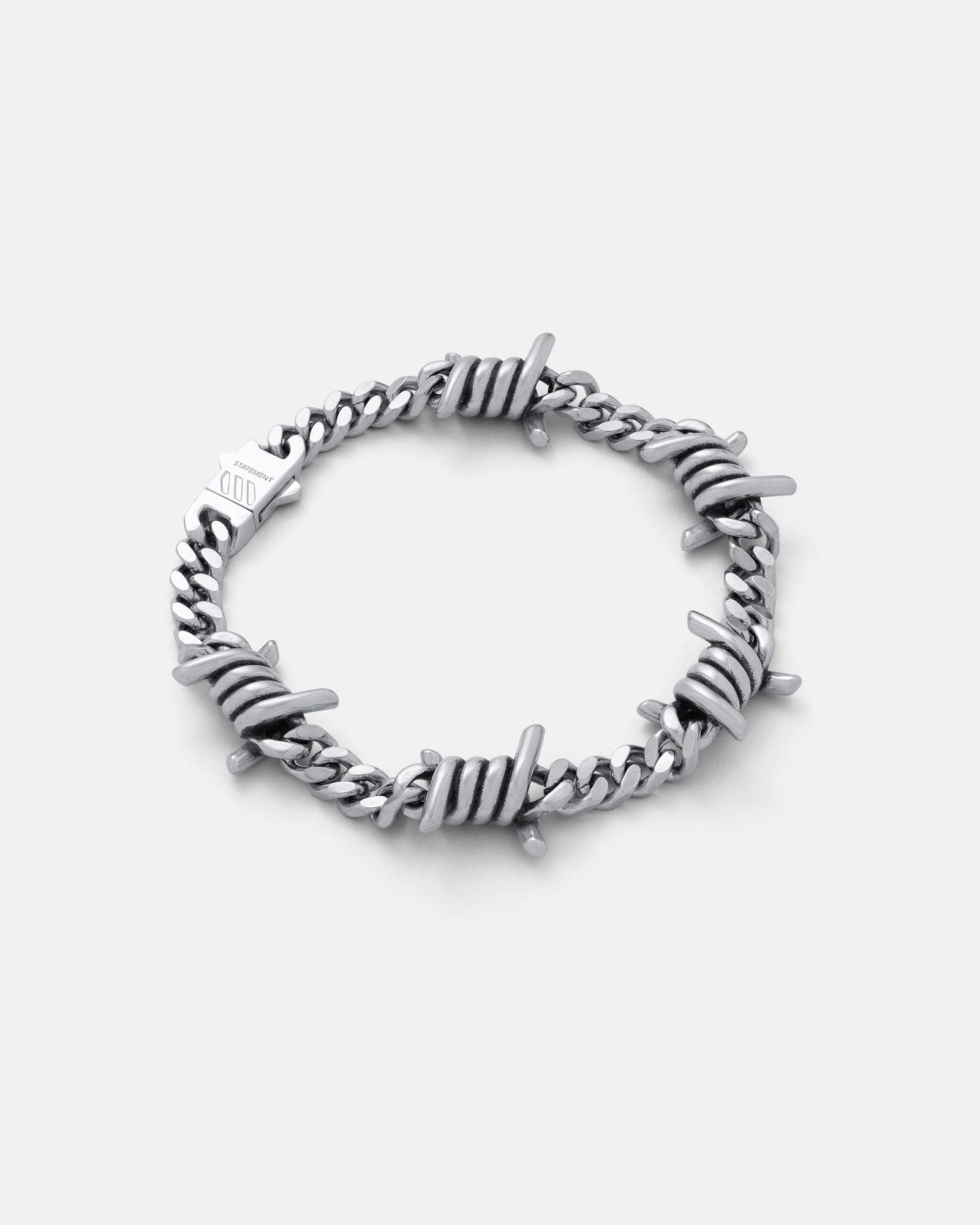 Silver 6mm barbed wire bracelet by statement collective on grey background