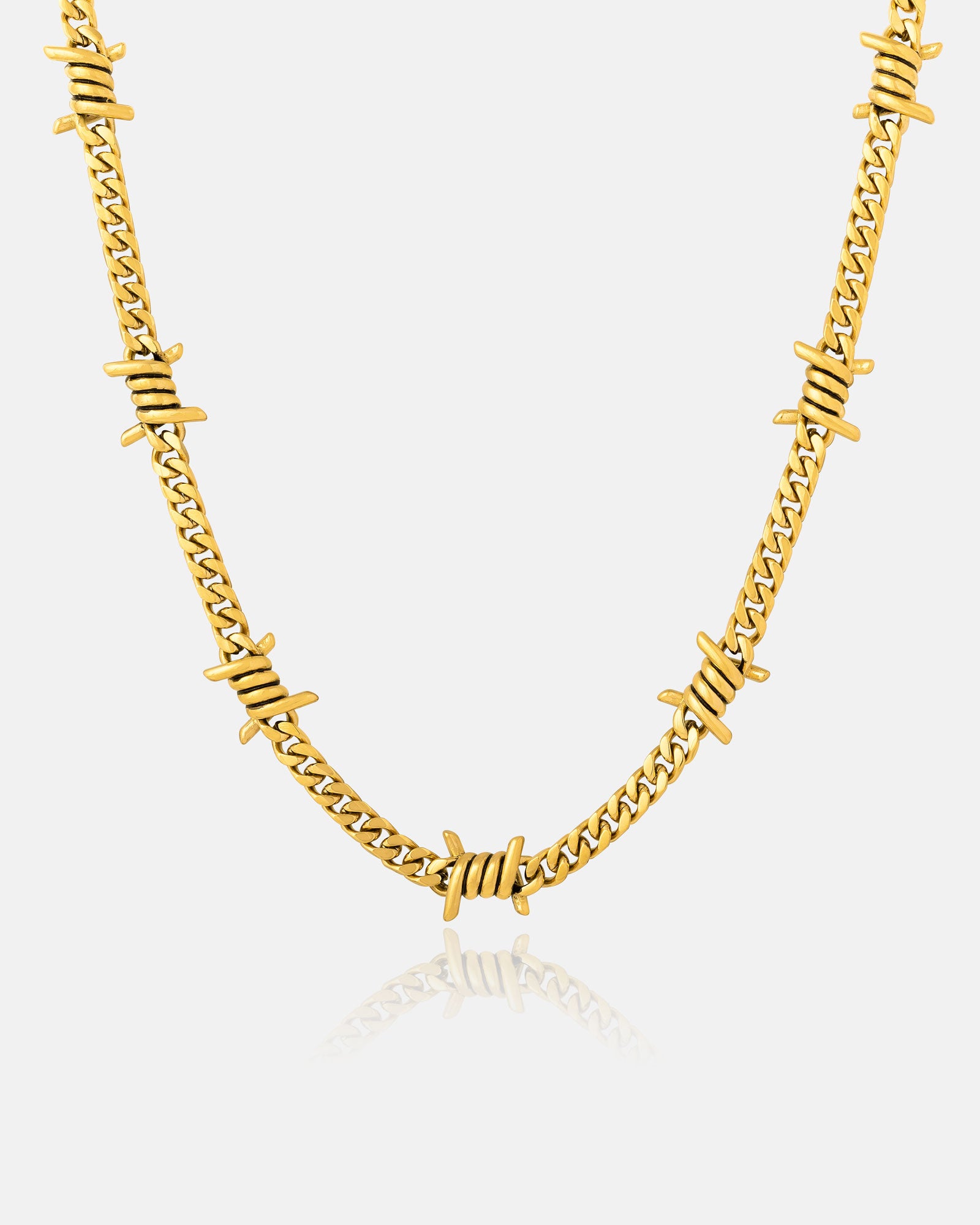 The 6mm Barbed Wire Cuban Chain (Gold) features a gold-plated Cuban link design with evenly spaced barbed wire-inspired accents, shown on a plain white background.