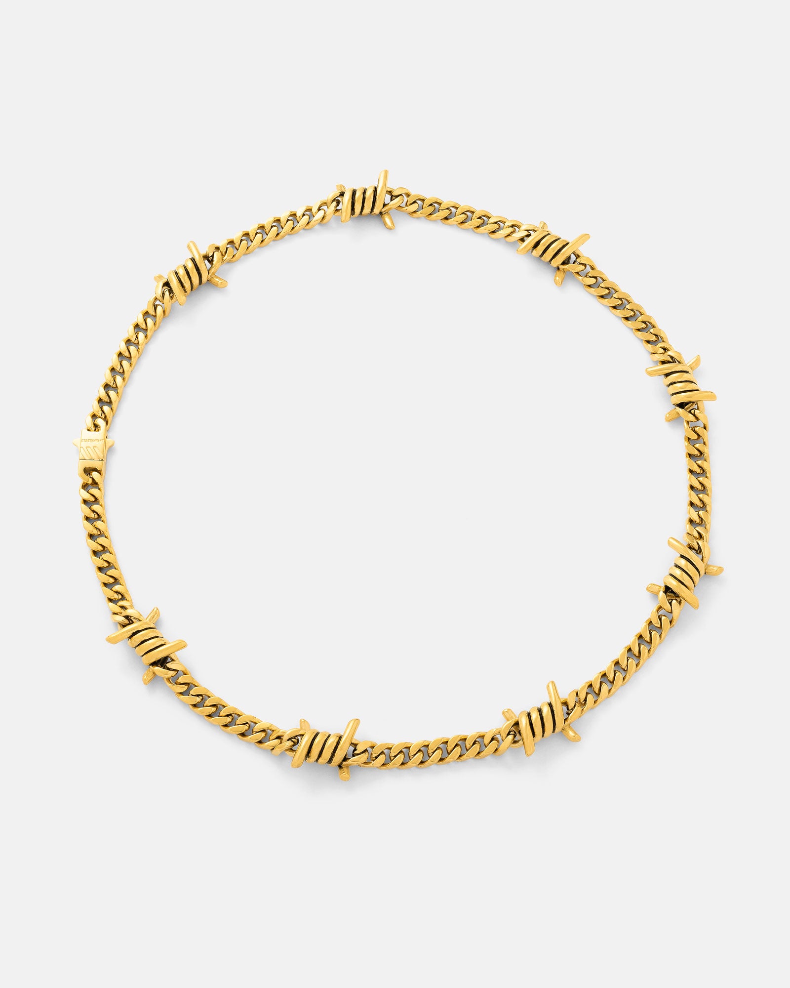 The 6mm Barbed Wire Cuban Chain (Gold) features evenly spaced, twisted barbed accents on an 18k gold-plated chain—displayed against a white background, this bold statement piece is part of the Echoes collection.
