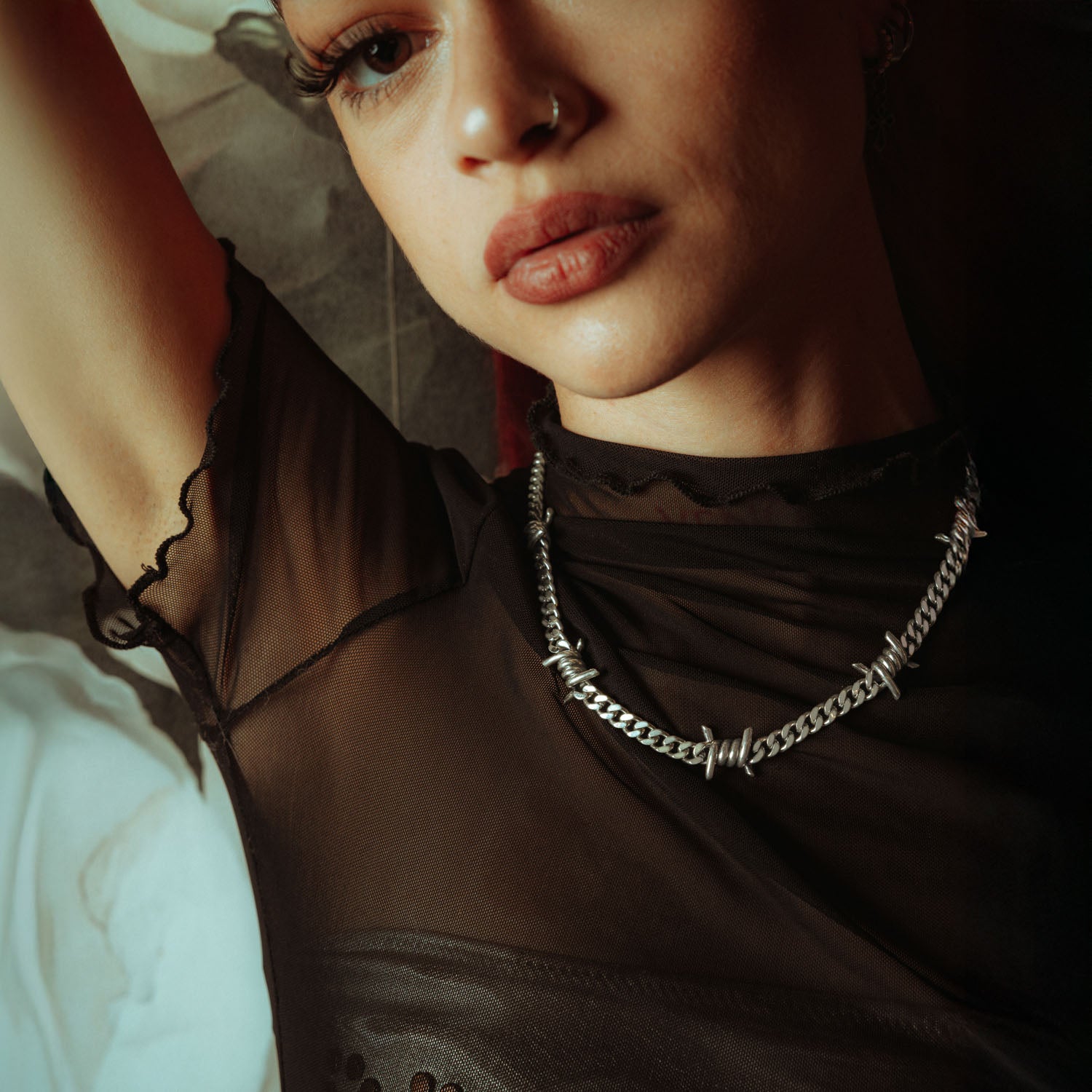 Sterling Silver 6mm Barbed wire chain on female model in mesh shirt