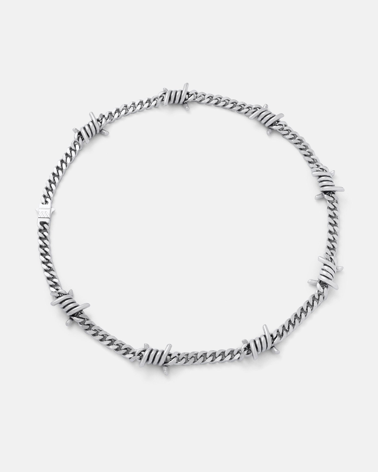 The 6mm Barbed Wire Cuban Chain is a statement silver necklace with evenly spaced barbed segments along its waterproof design, shown on a plain light gray background.