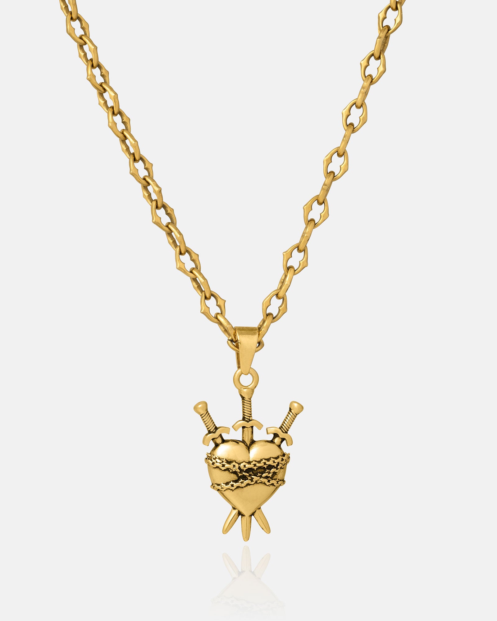 The Cathedral" 6mm Spiked Chain in gold with a custom pendant option is shown on a reflective white background.
