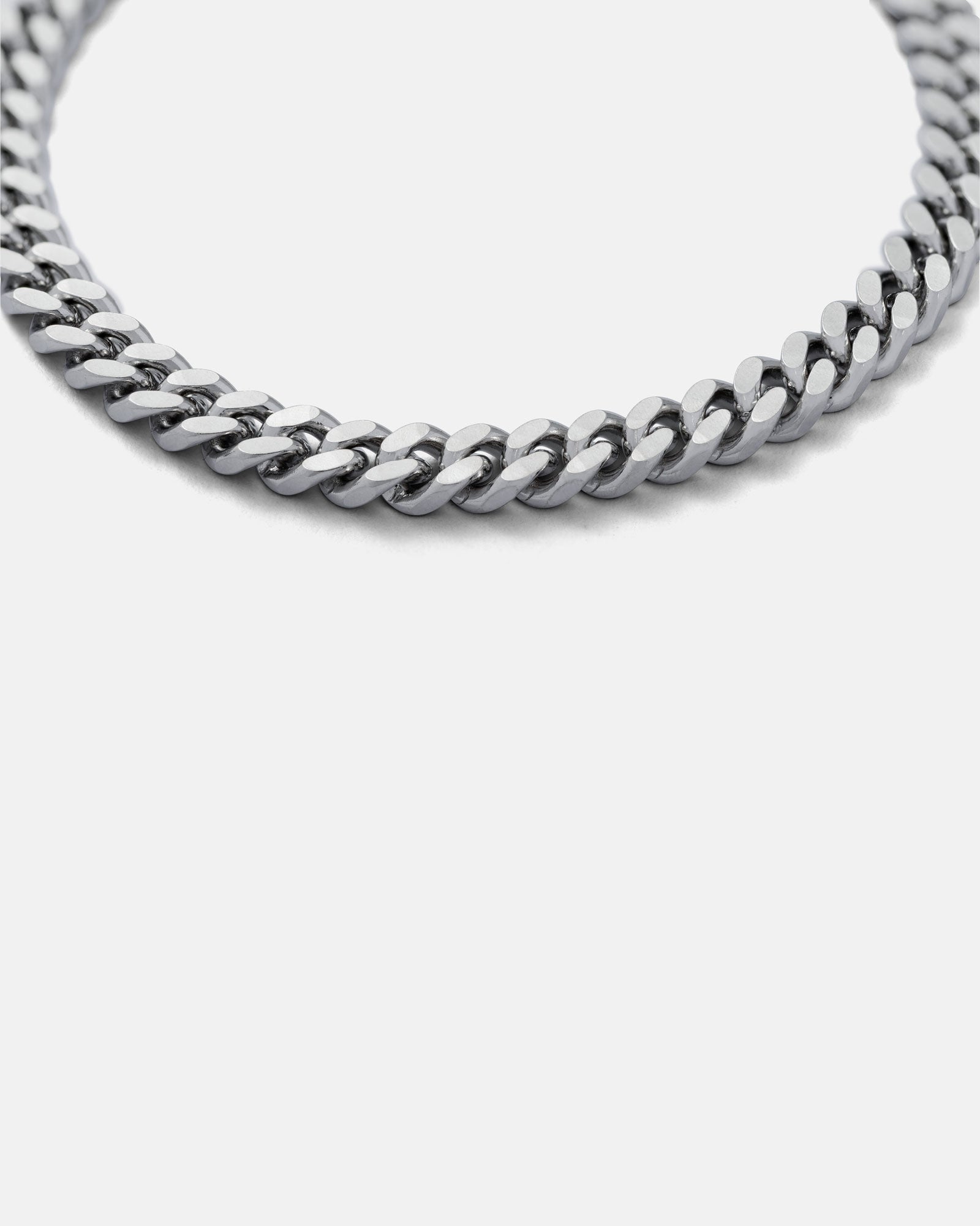 close up of silver 6mm cuban link bracelet on grey background