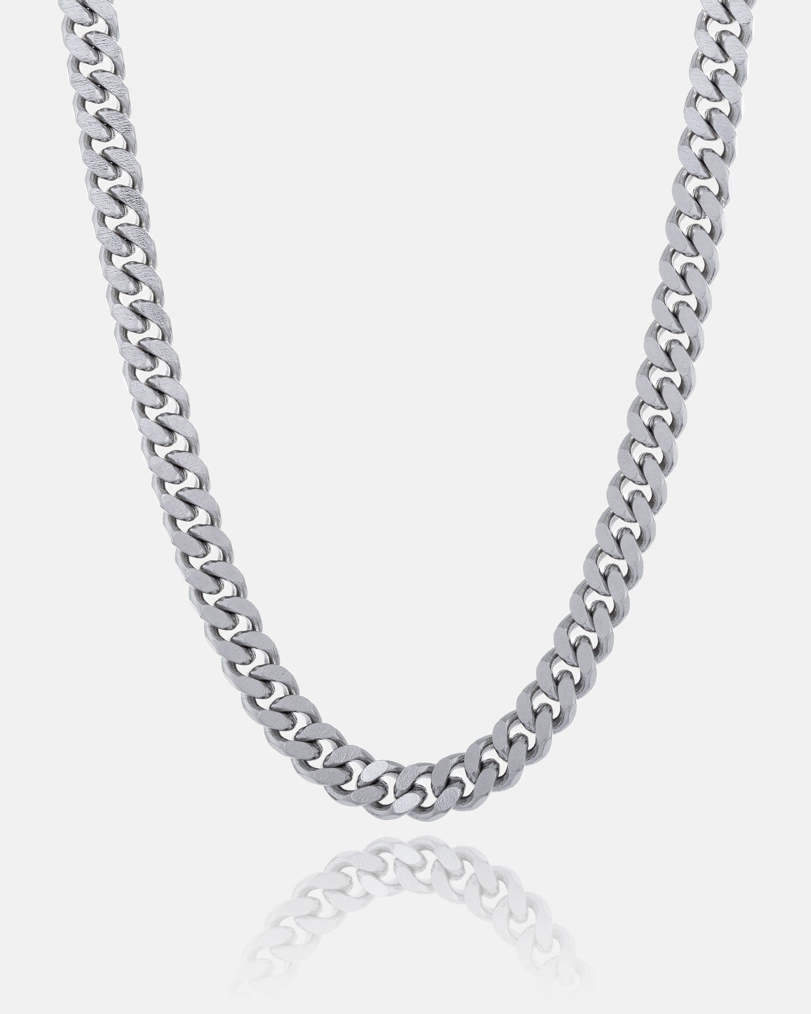 The 6mm Cuban Chain, made from stainless steel, is shown against a white background with its reflection below. This non-tarnish necklace offers lasting shine and durability.