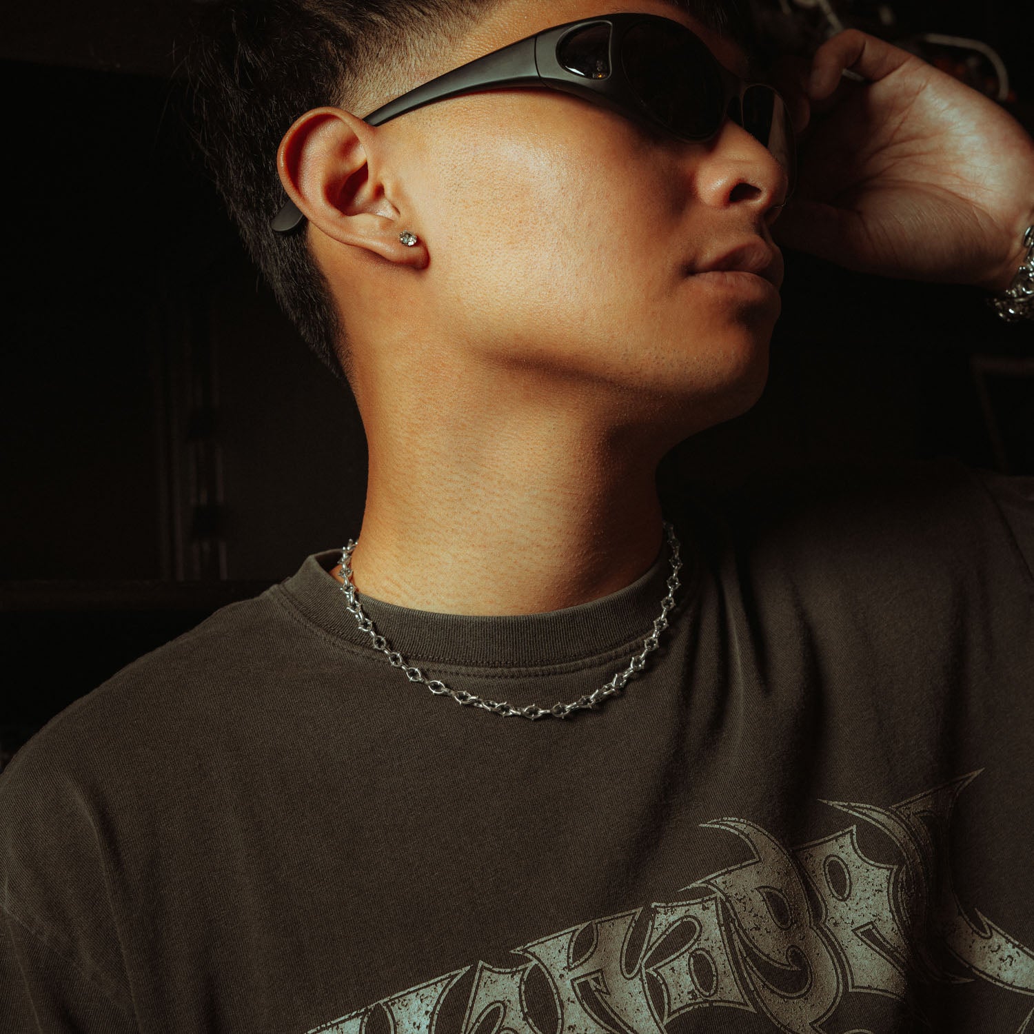 6mm spiked chain in sterling silver on male neck with grey shirt and sunglasses