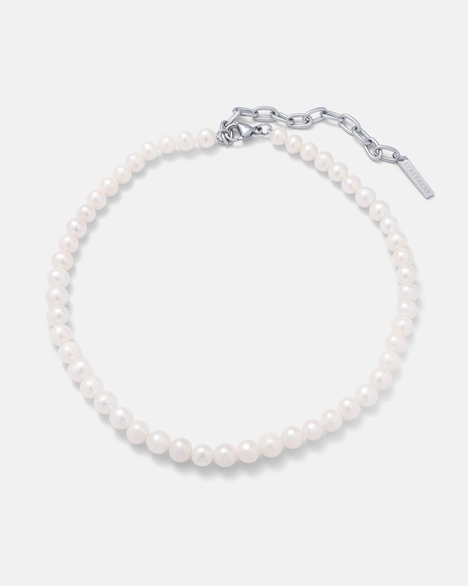The 8mm Freshwater Pearl Necklace is a single-strand piece with round white pearls and a silver adjustable chain clasp, complete with a small rectangular tag. Suitable for men and women, it’s elegantly displayed on a plain light background.