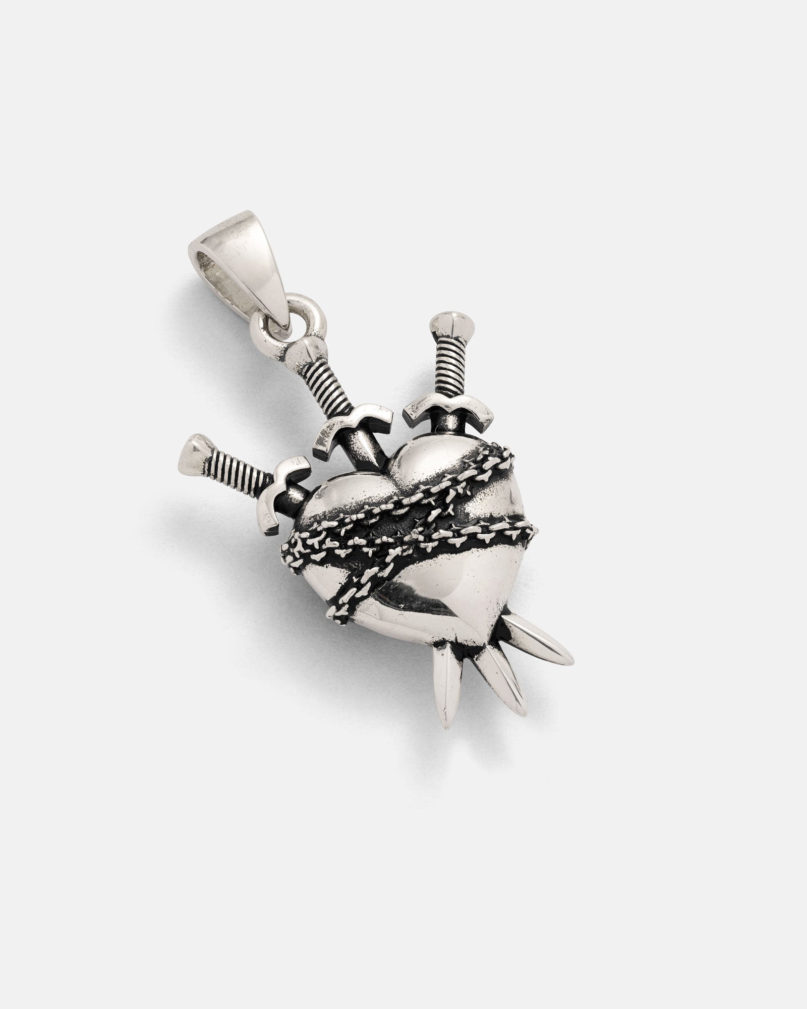 Introducing the 925 Sterling Silver "3 of Swords" Pendant by Statement Collective—a captivating piece showcasing a heart entwined in barbed wire and pierced by three swords, complete with a loop for easy attachment to your favorite chain. Ideal for tarot jewelry enthusiasts, this pendant is beautifully presented against a simple white background.