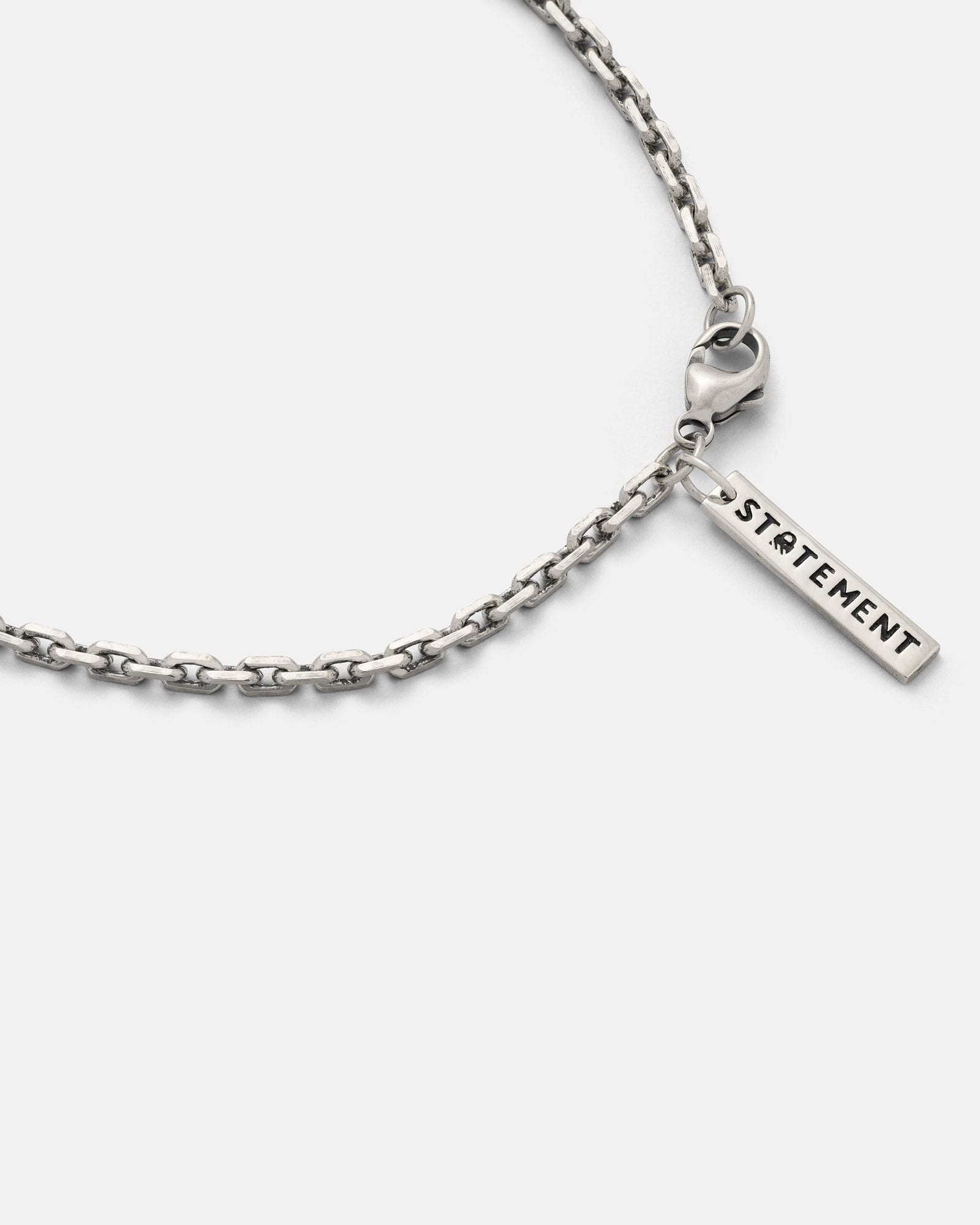 3mm cable chain with a 'STATEMENT' tag on a white background