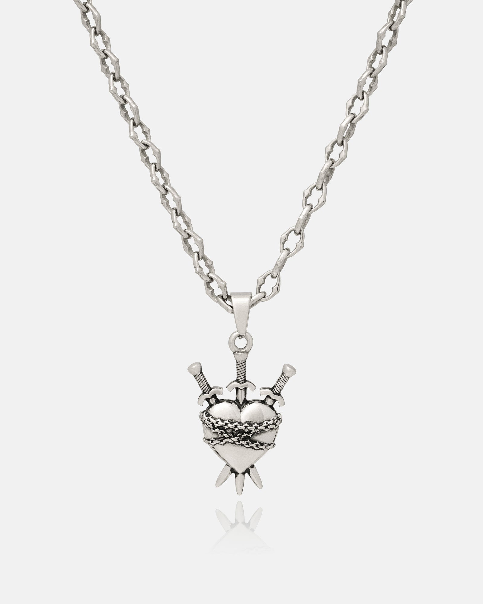 The 925 Sterling Silver "The Cathedral" 6mm Spiked Chain features a custom pendant, shown here as a polished heart wrapped in barbed wire and pierced by swords, all displayed on a white background.