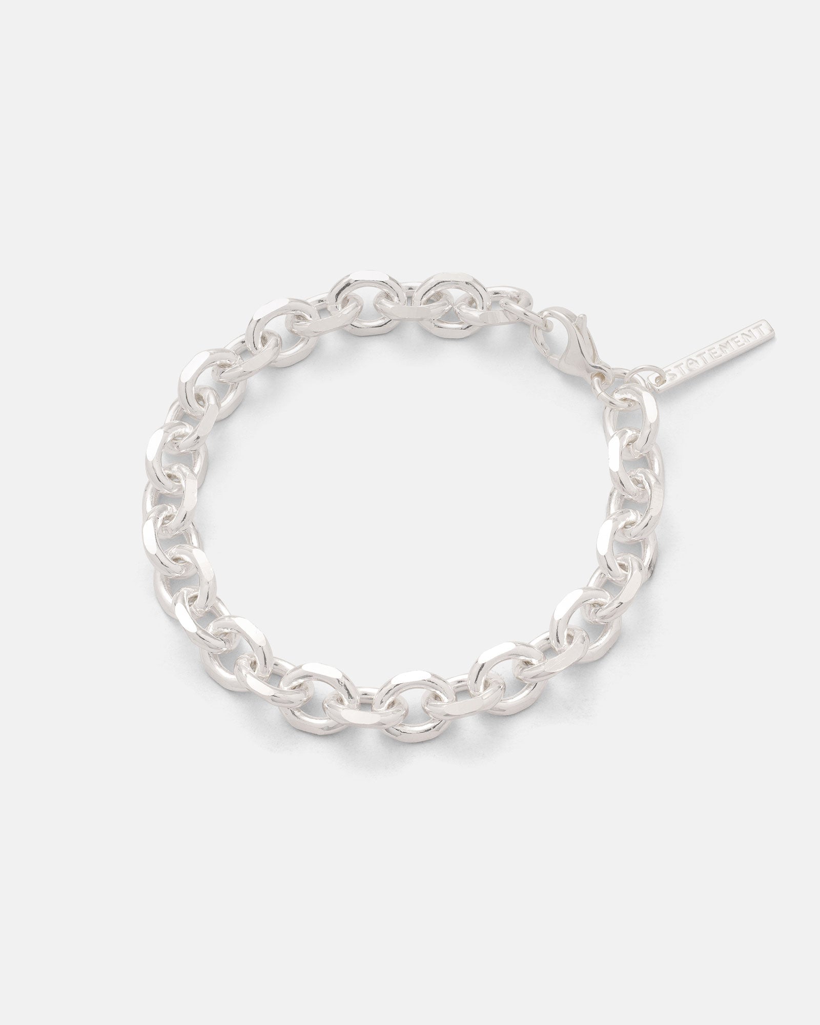 The Statement Collective 925 Sterling Silver 8mm Cable Bracelet showcases diamond-cut cable links and a petite rectangular tag, presented against a plain white background.