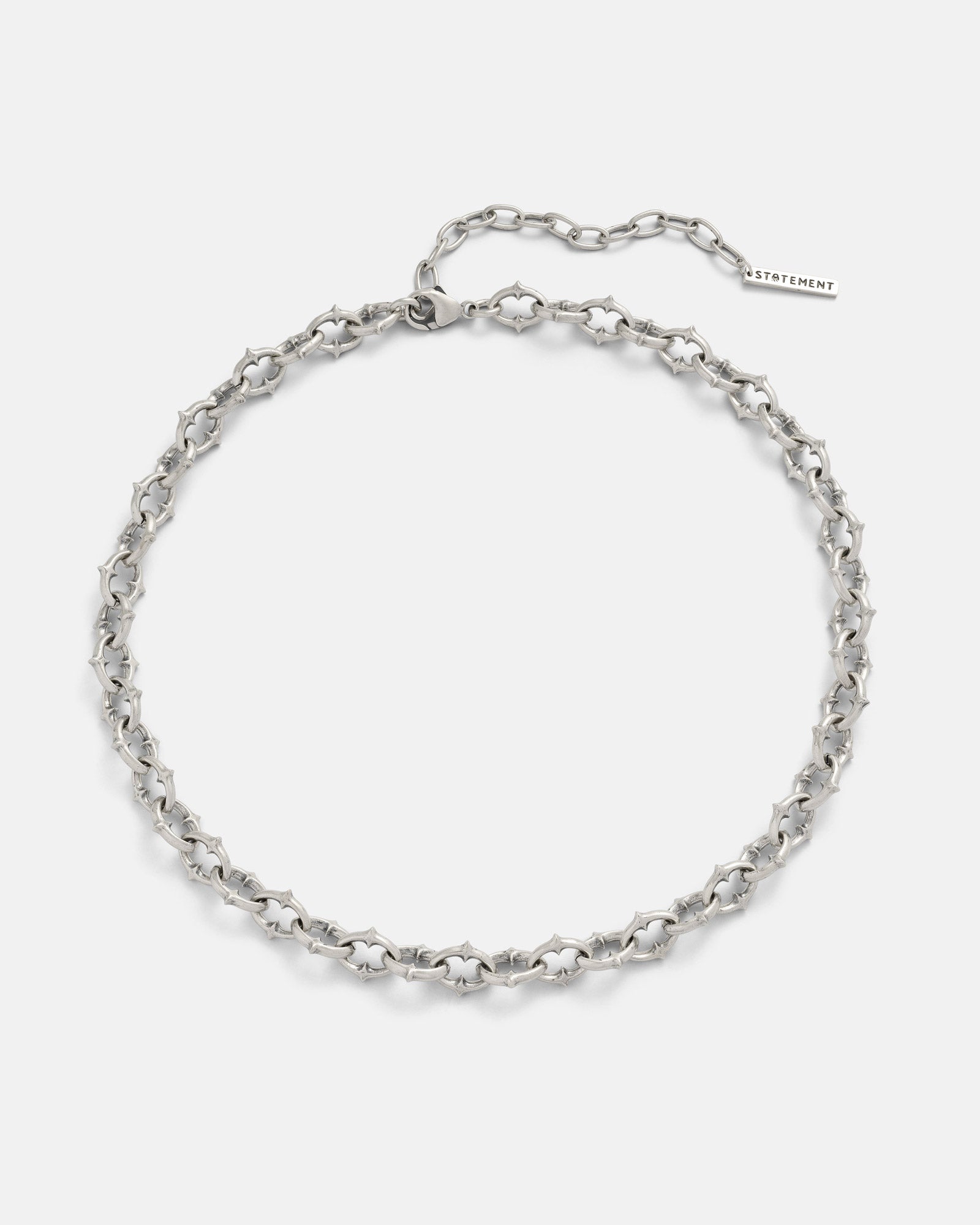 The 925 Sterling Silver "The Cathedral" 9mm Spiked Chain features an adjustable design with a rectangular tag at the clasp, showcased on a plain white background.