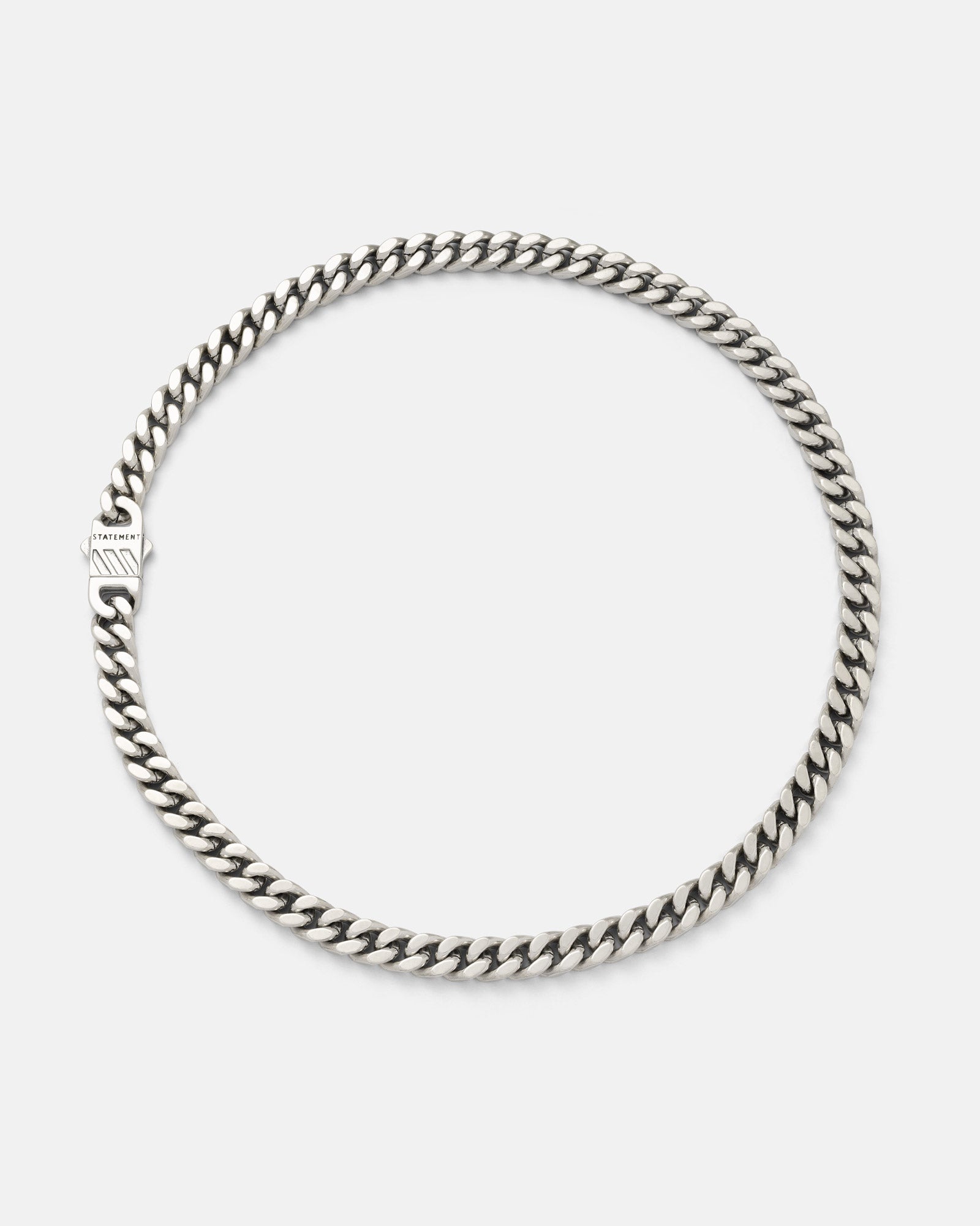Silver 9mm Cuban chain necklace on a light grey background