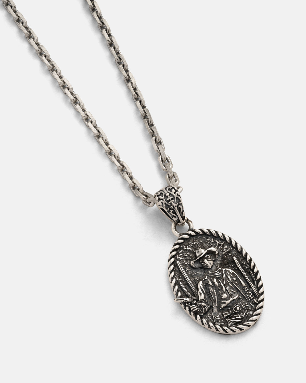 Elevate your style with the Statement Collective 925 Sterling Silver "Big Iron" Pendant: a silver chain necklace featuring an ornate oval pendant with a finely detailed, raised image of a historical figure in a hat and cloak, framed by a braided border—an eye-catching piece perfect for those who appreciate unique, vintage-inspired artistry in sterling silver jewelry.