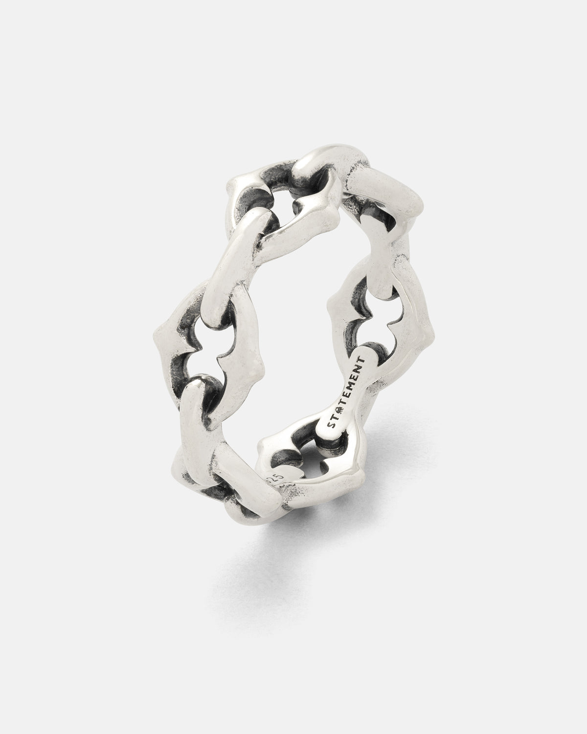 A 925 sterling silver “The Cathedral” Spiked Ring by Statement Collective, featuring an interlocking geometric chain link band design with a matte finish, displayed on a plain white background. The inside of the ring is engraved with text.