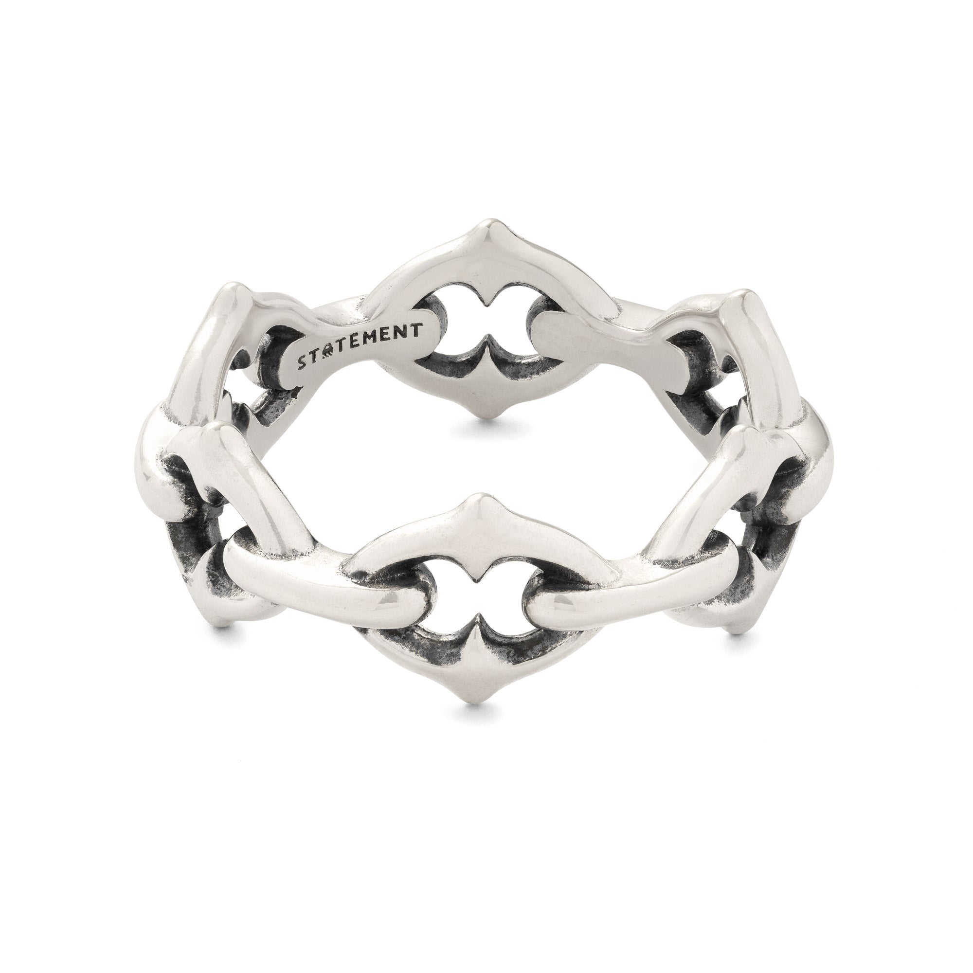 Sterling Silver ring with intricate spiked design on a white background by statement