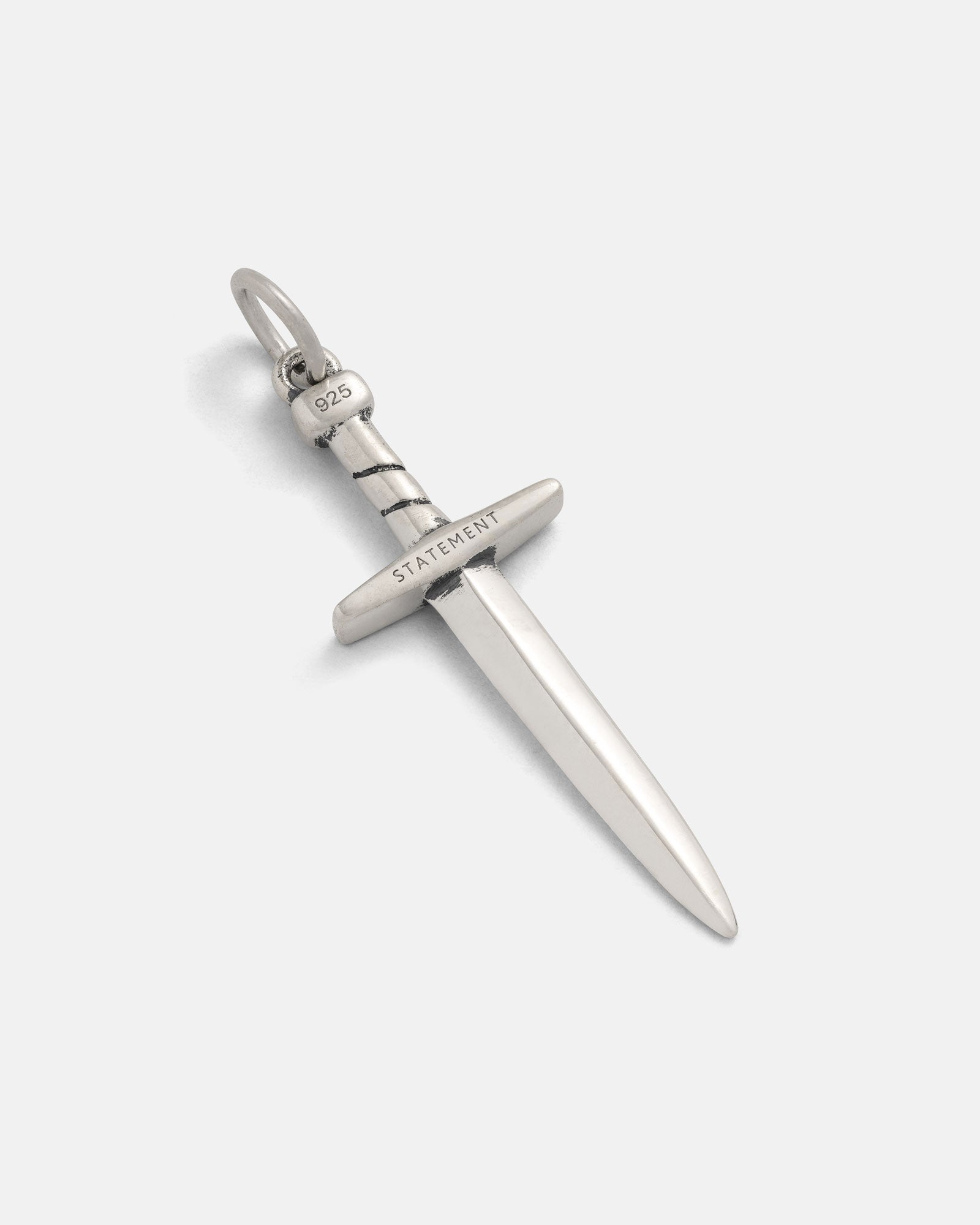 The 925 Sterling Silver Dagger Pendant, featuring "STATEMENT" on the cross-guard and "925" on the handle, is shown against a plain white background—a striking piece of handmade sterling silver jewelry.