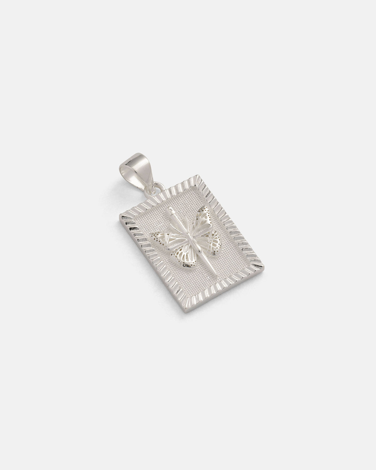 Introducing the 925 Sterling Silver Mini Butterfly Tag Pendant by Statement Collective—a rectangular pendant crafted in sterling silver, featuring a raised butterfly design at its center, textured edges, and a smooth bail for easy attachment to your favorite necklace. This piece exemplifies the refined craftsmanship for which Statement Collective is renowned.