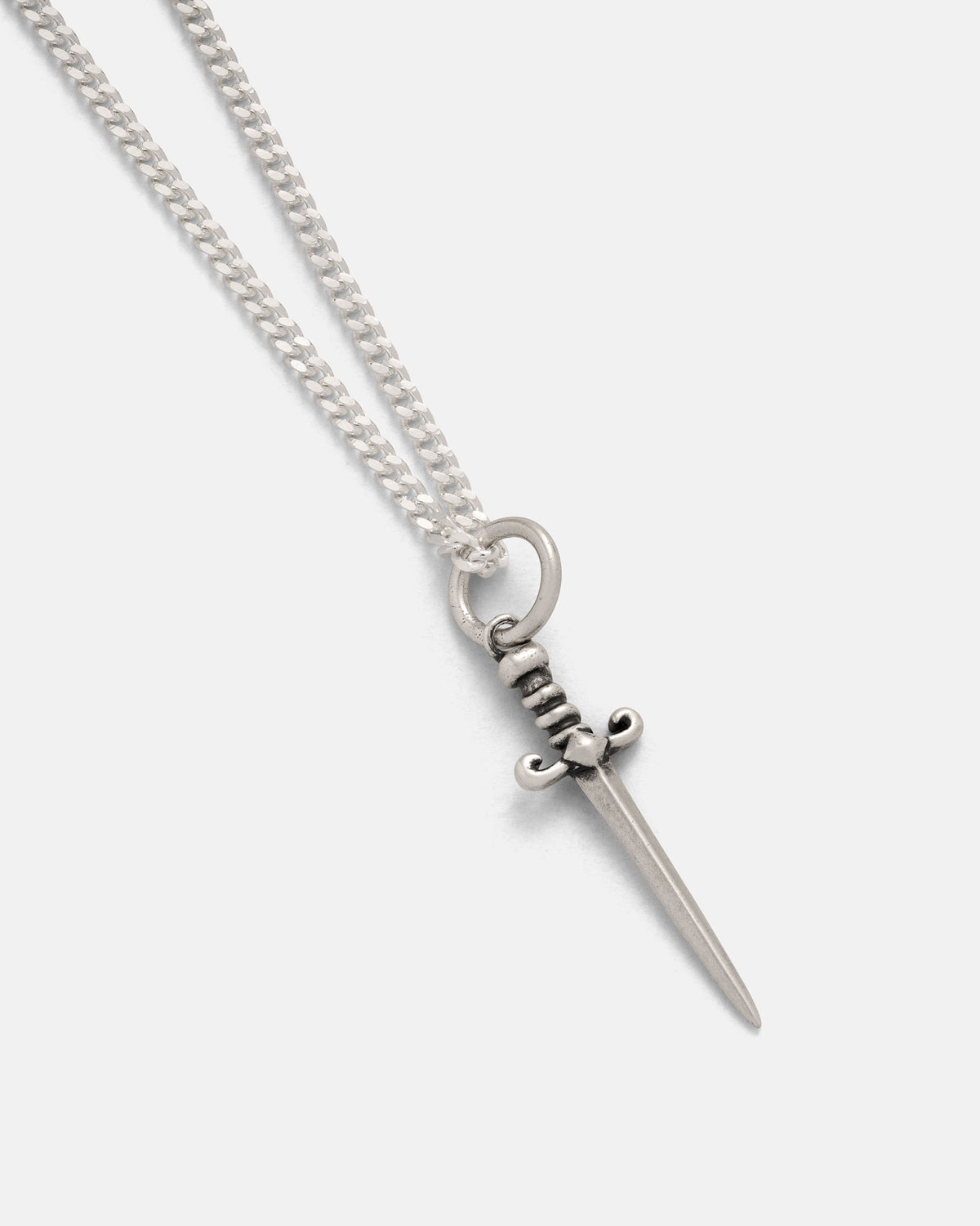The 925 Sterling Silver Mini Dagger Pendant by Statement Collective, featuring a finely crafted sword-shaped pendant on a sleek chain, showcases the bold style of rock-inspired jewelry as it rests elegantly against a plain light background.