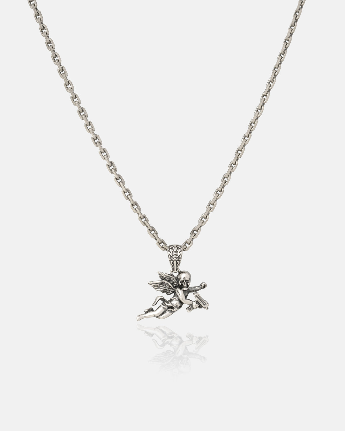 The 925 Sterling Silver Mini "Deaths Cupid" Pendant by Statement Collective features a finely detailed cherub with outstretched wings holding an object, suspended from a silver chain and shown against a plain white background—an ideal piece to layer with your favorite rock jewelry or style alongside a bold heart pendant for an edgy yet refined look.