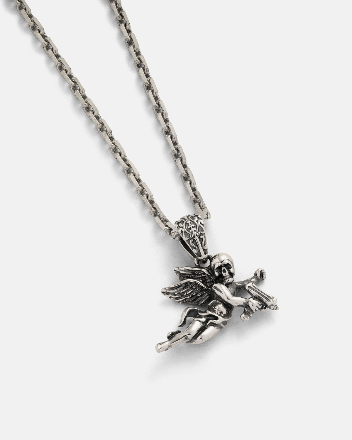 The 925 Sterling Silver Mini "Deaths Cupid" Pendant by Statement Collective features a finely crafted winged skeleton angel, embodying the bold essence of rock jewelry, displayed against a simple light backdrop.