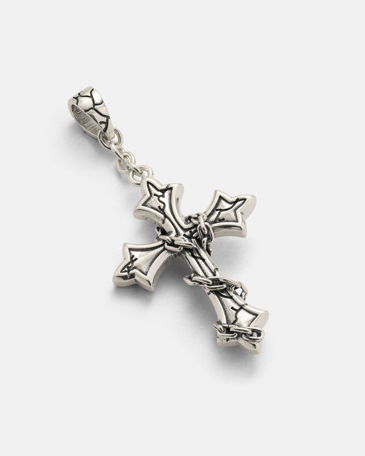 The 925 Sterling Silver Mini “The Ruins” Cross Pendant by Statement Collective features pointed tips and a wrapped-chain design with intricate barbed wire detailing, attached to a loop for wearing on a necklace—a striking piece of gothic jewelry.