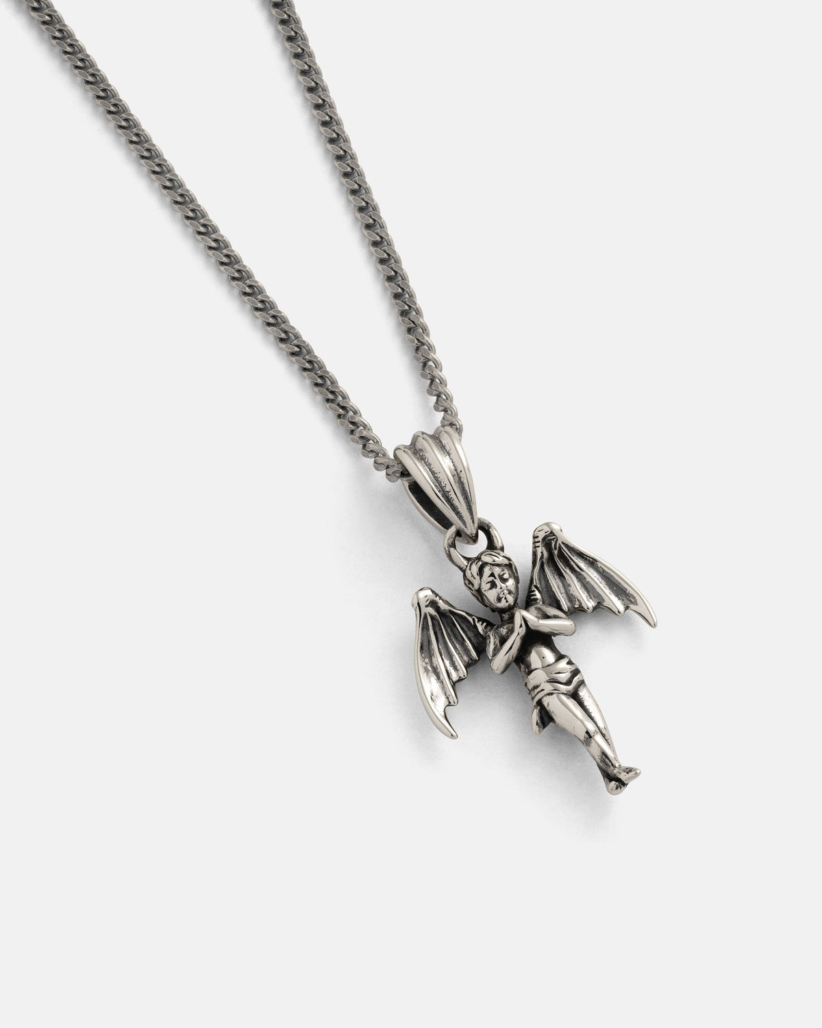 Statement Collective’s 925 Sterling Silver "The Wicked One" Pendant takes sterling silver jewelry in a celestial direction, featuring a winged angel design with arms crossed over its chest. Photographed against a plain white background, this necklace fuses timeless elegance with the bold spirit characteristic of punk metal jewelry.