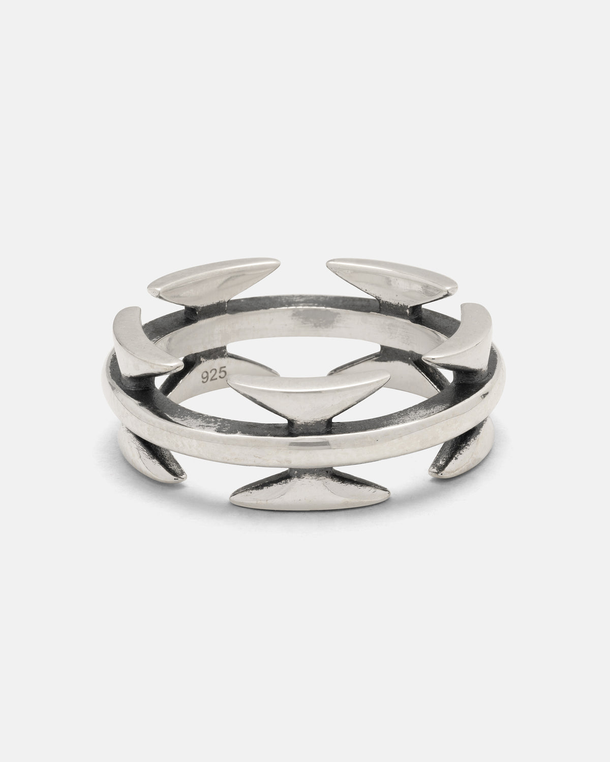 The 925 Sterling Silver Razor Wire Ring by Statement Collective features a distinctive open design accented with pointed, crescent-shaped elements evenly spaced around the band, embodying a bold style reminiscent of tattoo-inspired jewelry.