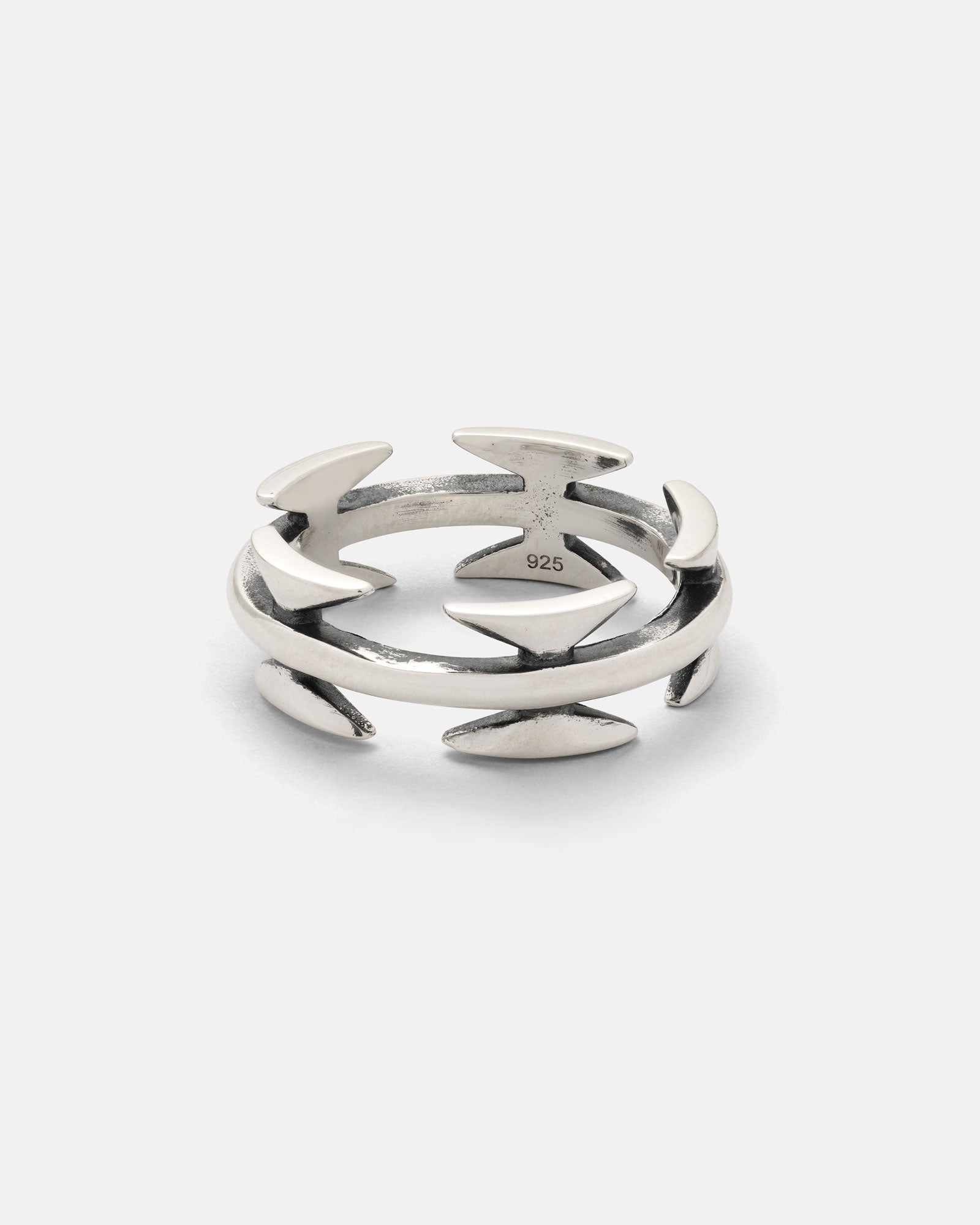 The 925 Sterling Silver Razor Wire Ring features an open design with pointed, razor wire-inspired shapes spaced around the band, taking cues from tattoo-inspired jewelry. It is shown against a plain white background.