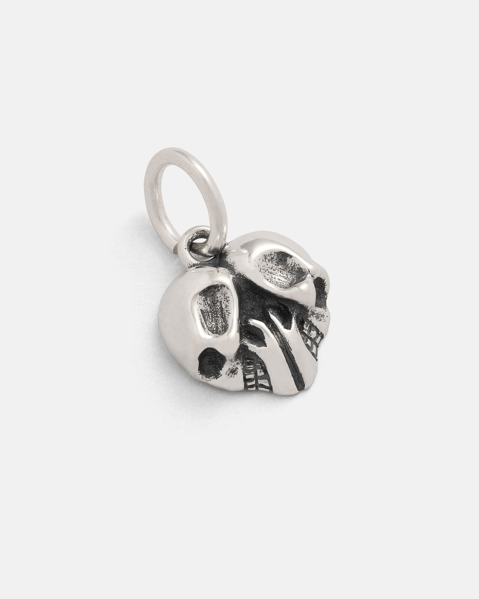 The 925 Sterling Silver Skull Heart Pendant is a small metallic charm with prominent eye sockets, blackened detailing, and a top loop for easy attachment—a perfect rock-inspired jewelry piece.