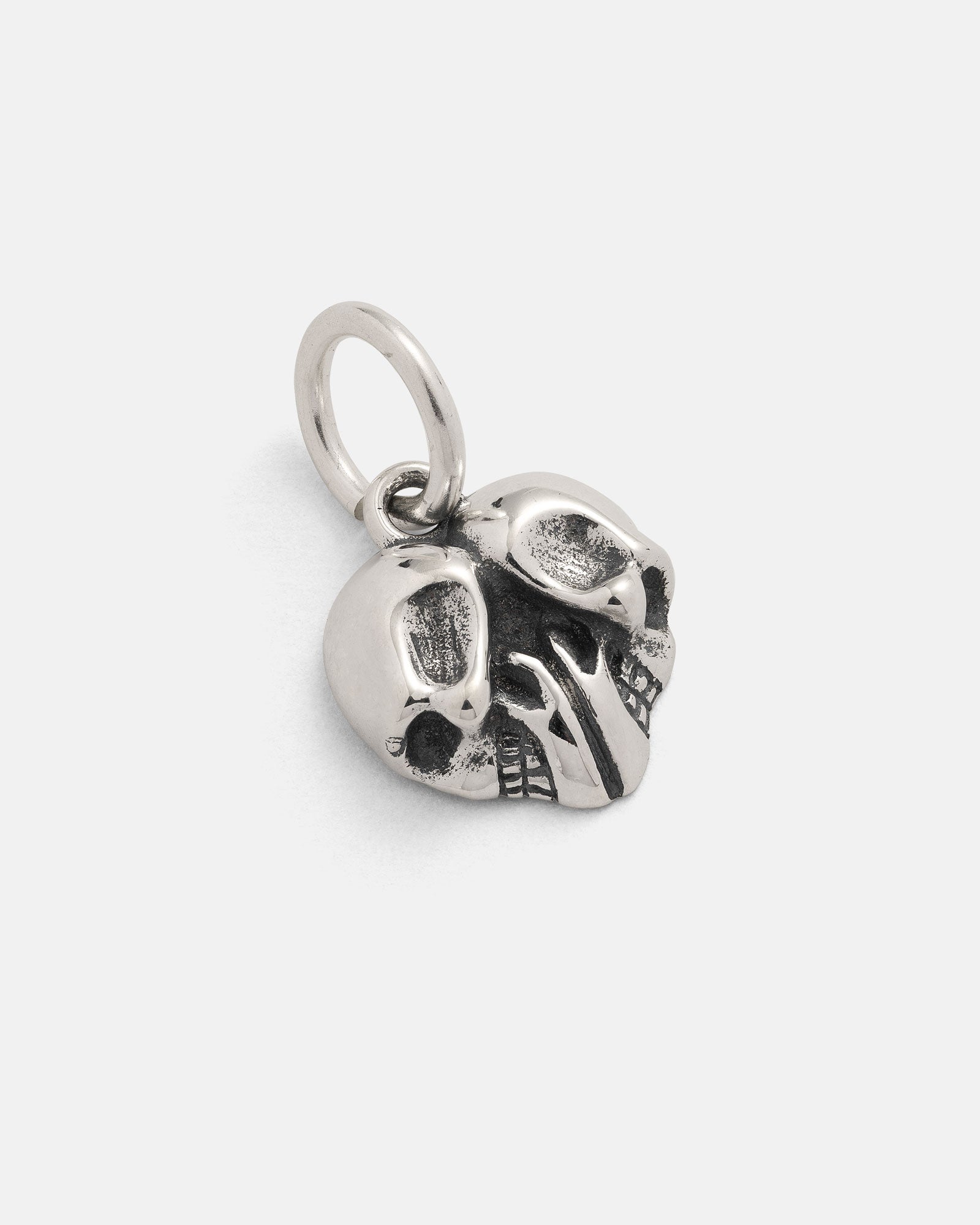 The Statement Collective 925 Sterling Silver Skull Heart Pendant is a small silver charm designed in the shape of a skull, featuring prominent eye sockets and teeth with a handy loop at the top for attaching to your favorite necklace or bracelet. This sterling silver pendant is perfect for bringing an edgy accent to your rock jewelry collection.