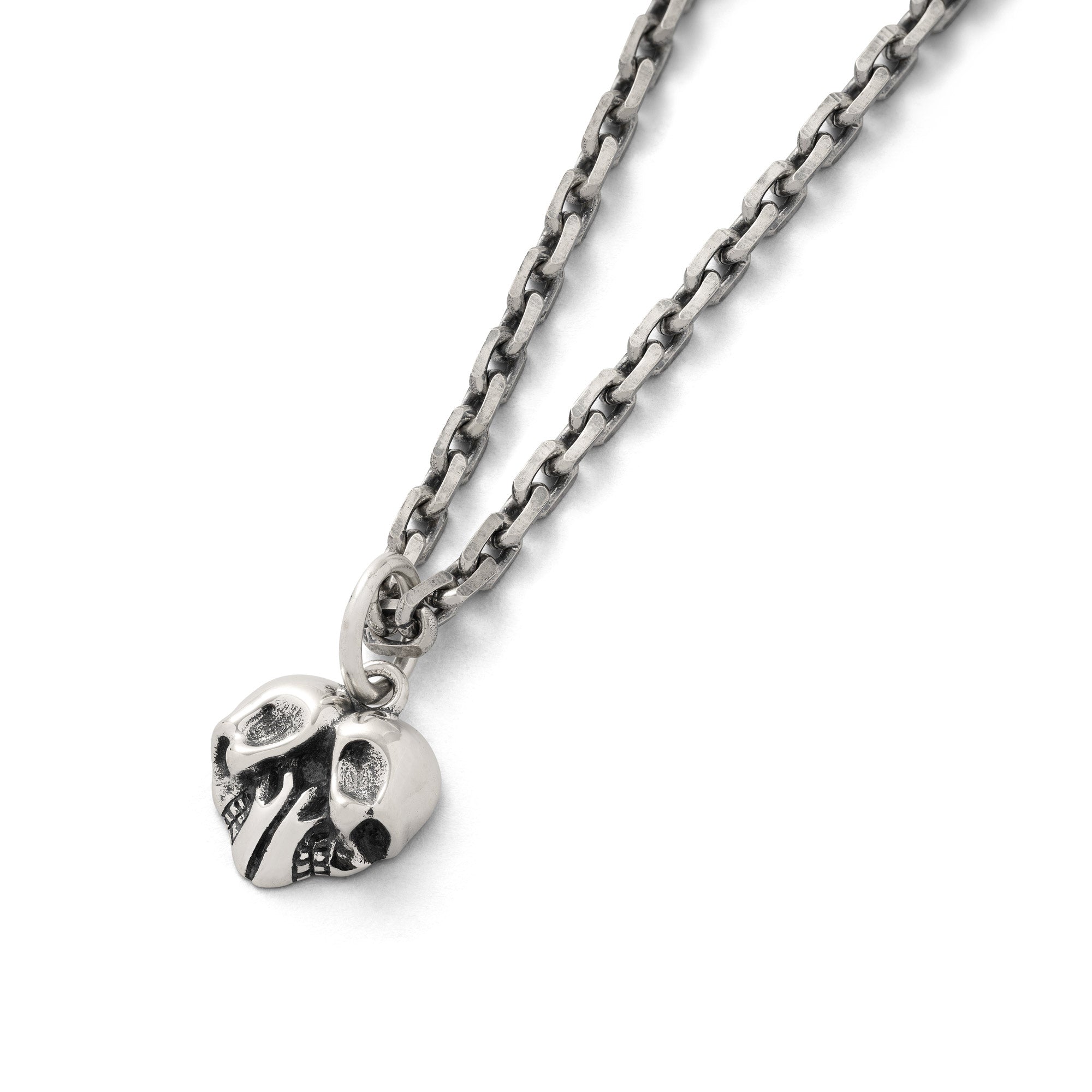 Heart shaped pendant with 2 skulls facing outwards in 925 sterling silver by statement collective