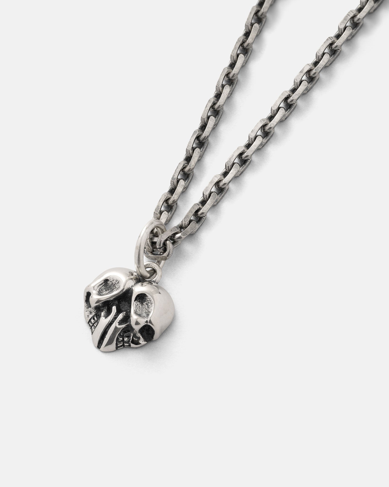 A 925 Sterling Silver Skull Heart Pendant from Statement Collective, featuring darkened eye sockets and displayed on a plain white background—perfect for fans of unique rock jewelry.