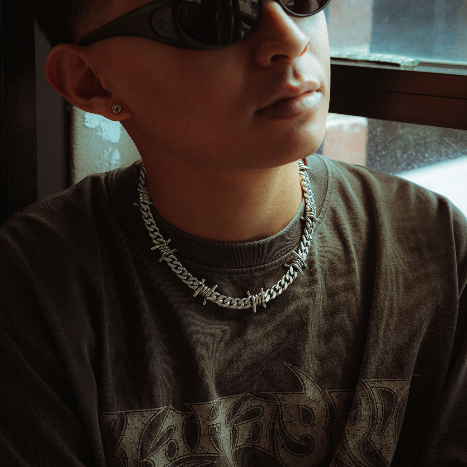 Sterling Silver 9mm Barbed wire chain on male model with grey shirt and sunglasses