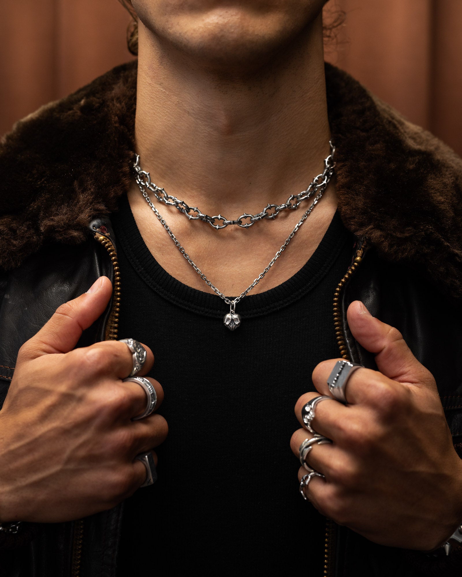 model wearing layered 925 sterling silver necklaces by statement collective