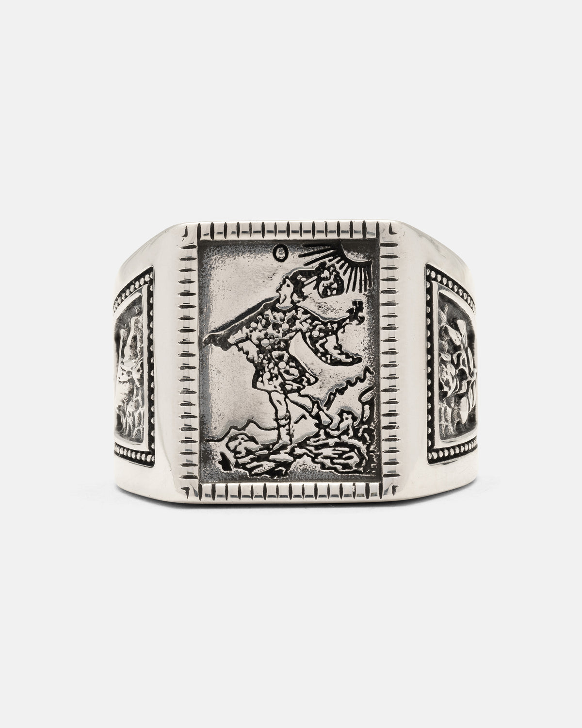 Statement Collective 925 Sterling Silver Try Hard Fool ring featuring a rectangular face with an engraved depiction of a figure walking toward a cliff edge under a sun, with additional detailed carvings on the side panels.
