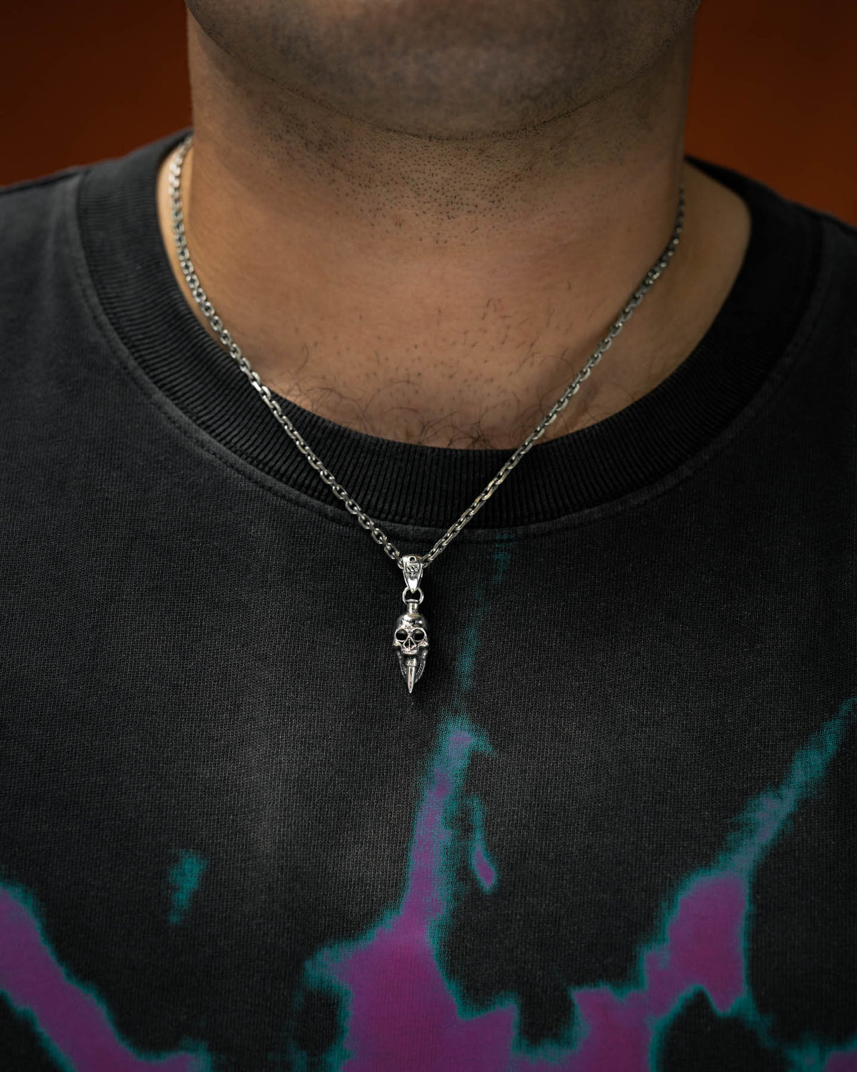 925 silver mini bite the bullet pendant by statement collective on man's neck