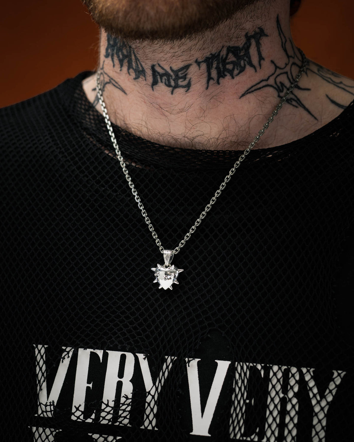 tattooed man wearing spiked heart pendant necklace in 925 sterling silver