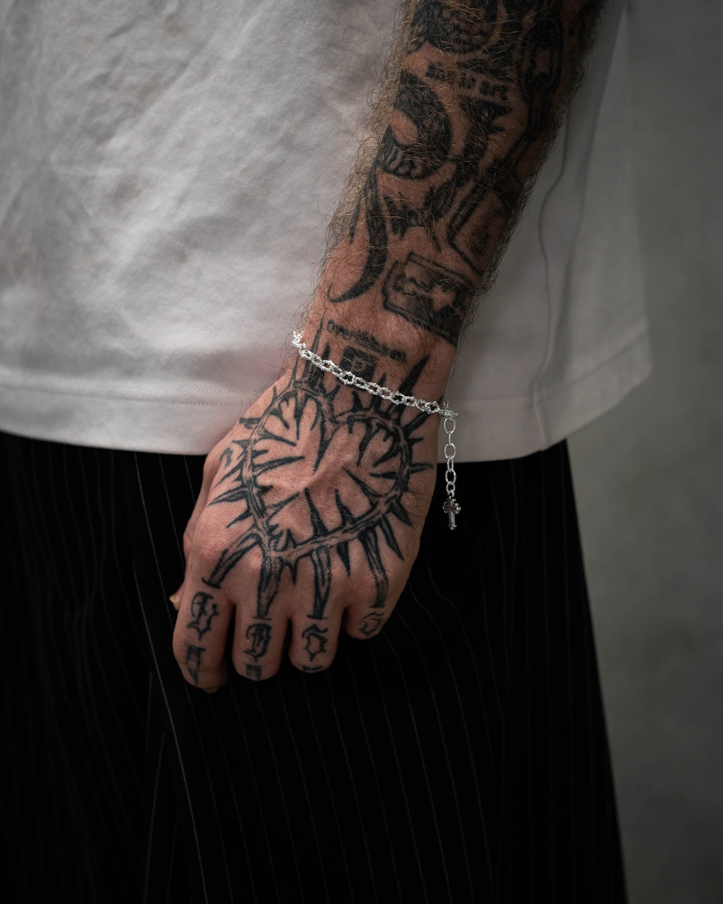 tattooed mens arm with spiked chain bracelet in 925 sterling silver