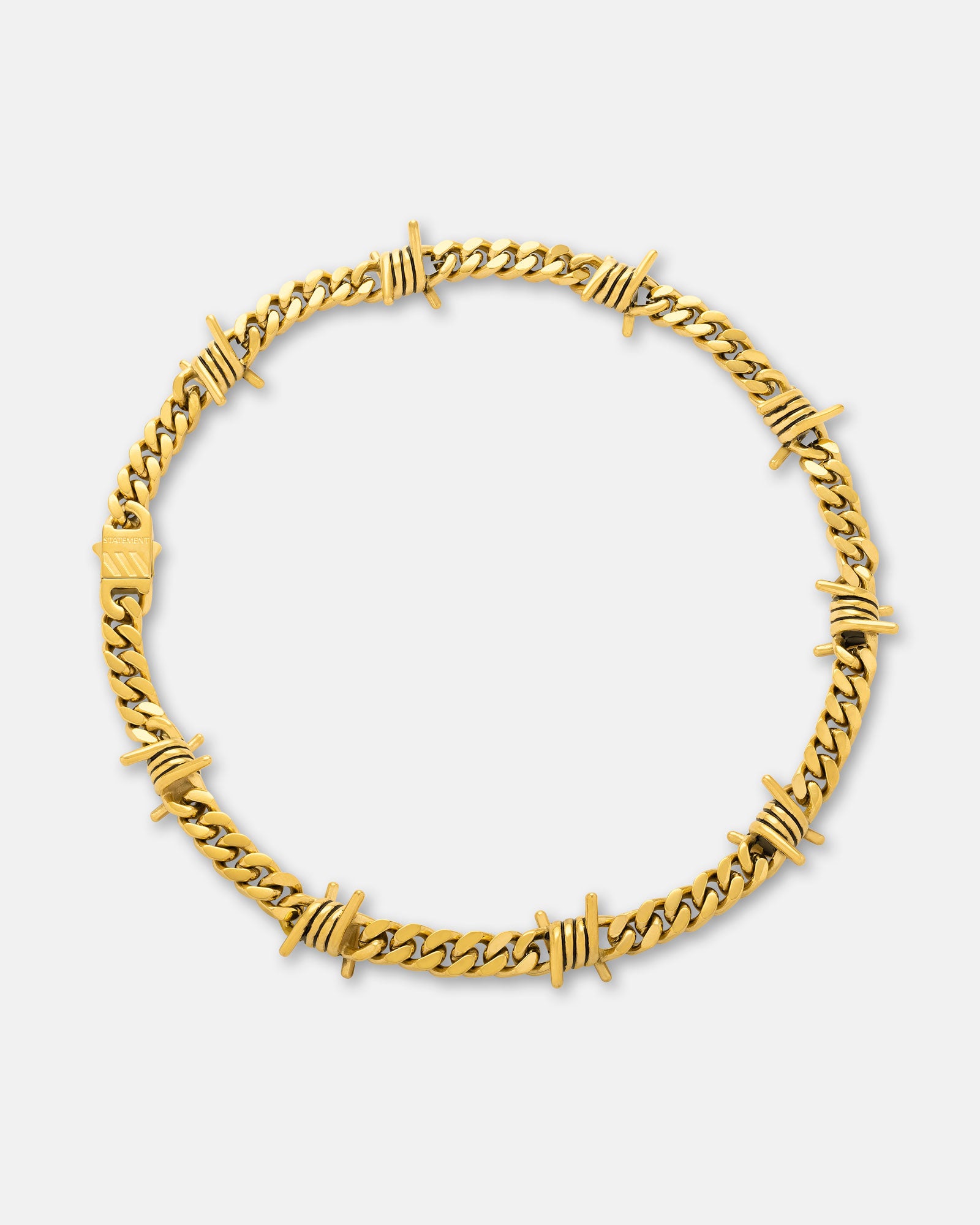 The 9mm Barbed Wire Cuban Chain (Gold) features twisted barbs spaced along a circular Cuban link design, crafted in gold and showcased against a plain white background.