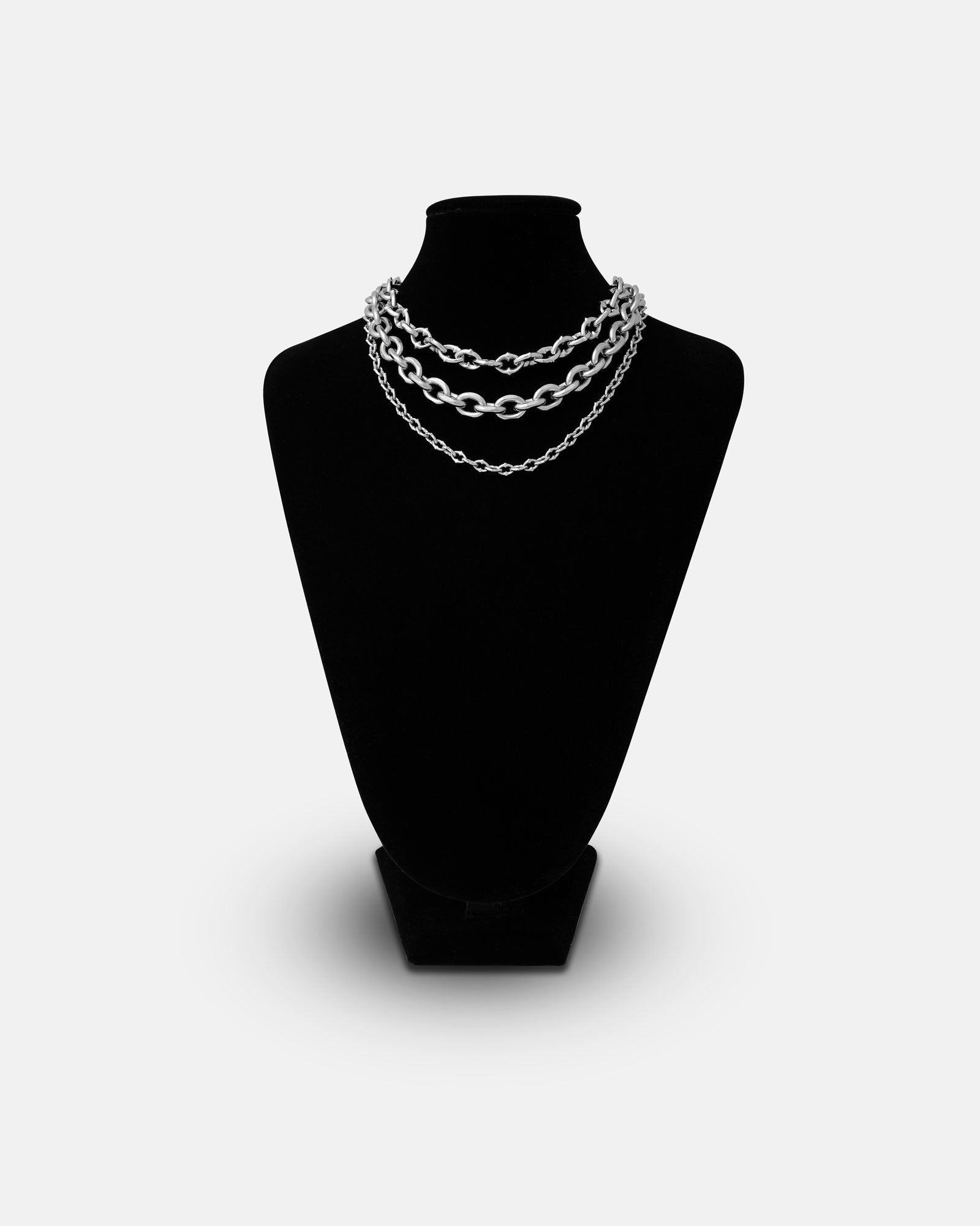 The Go To Church Stack, a layered silver chain necklace with three chunky link rows, is displayed on a black jewelry bust against a plain white background.