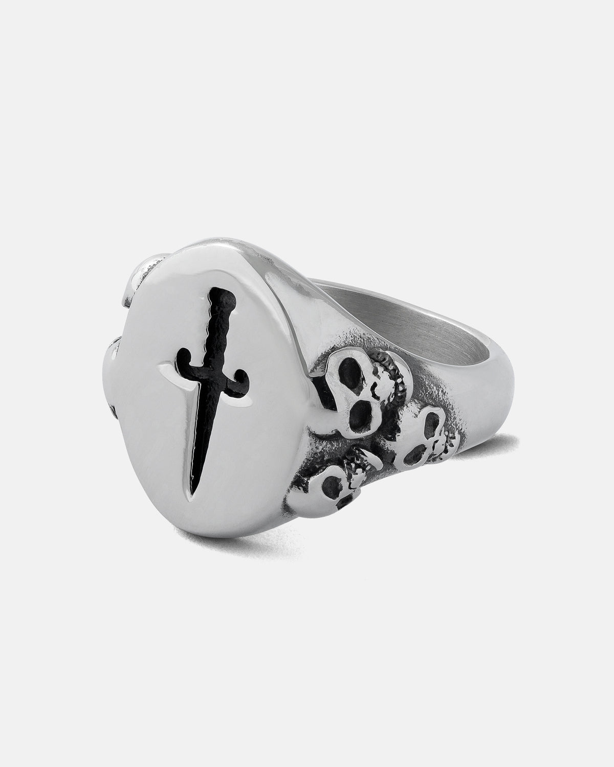 A silver Graveyard Signet Ring by Statement Collective, showcasing a raised circular face engraved with a sword design and skull details along the band, set against a plain white background.