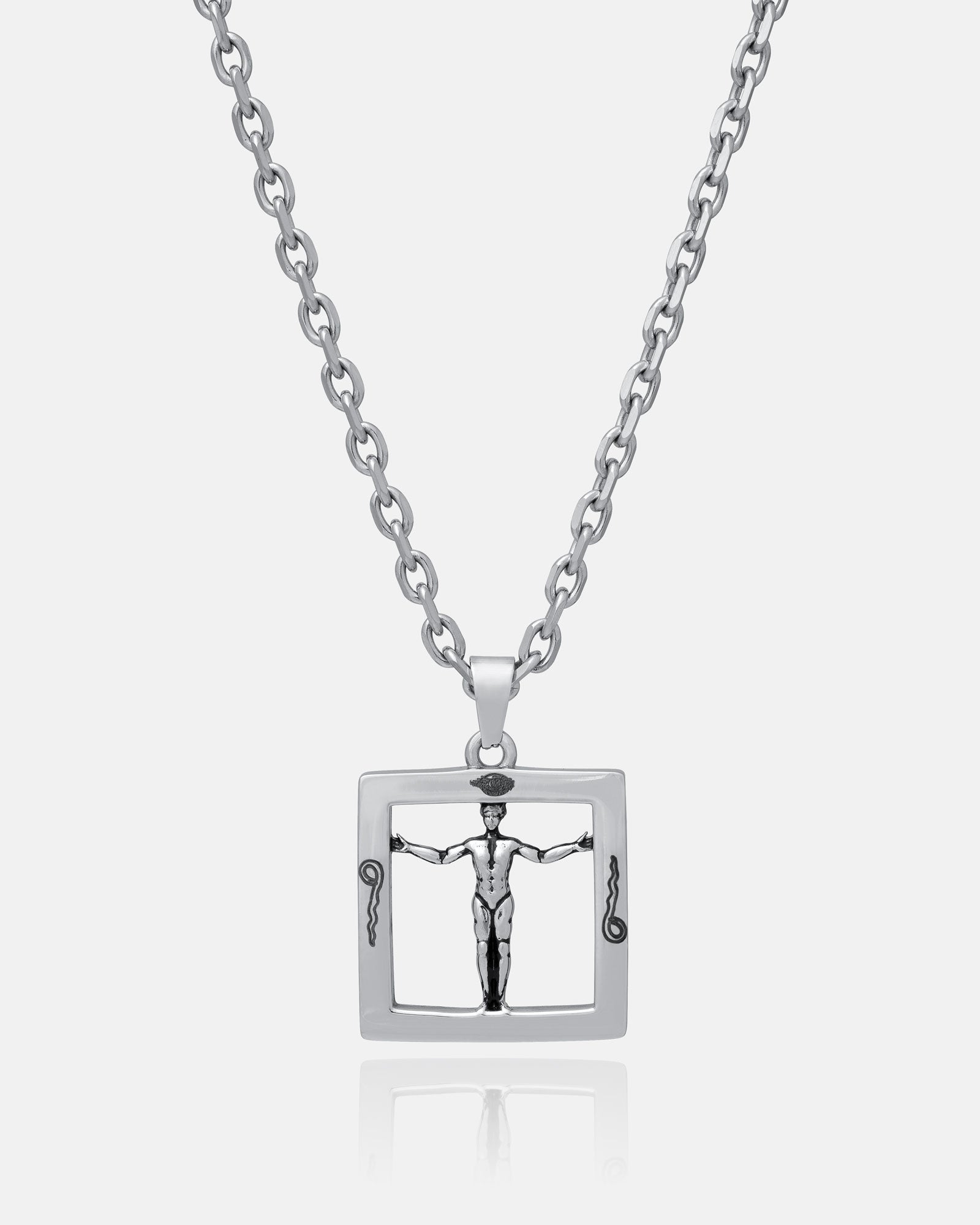 Agrippa’s Square Pendant: a silver chain necklace with a rectangular pendant featuring a raised figure with outstretched arms, framed by vertical snake-like forms—a bold occult jewelry piece inspired by divine proportions.