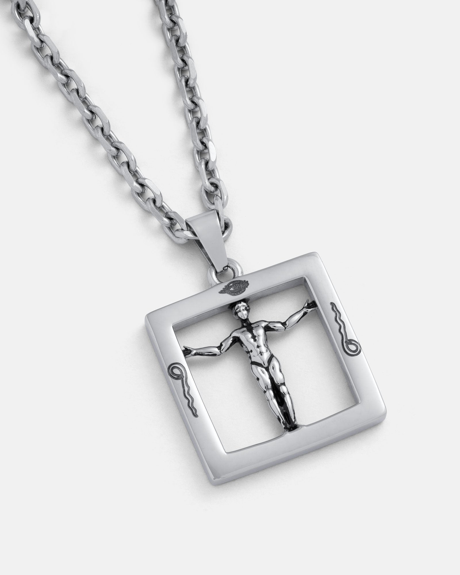 Agrippa’s Square Pendant is a silver chain necklace featuring a square pendant with a raised, stylized man with outstretched arms and decorative corner details, inspired by occult jewelry.