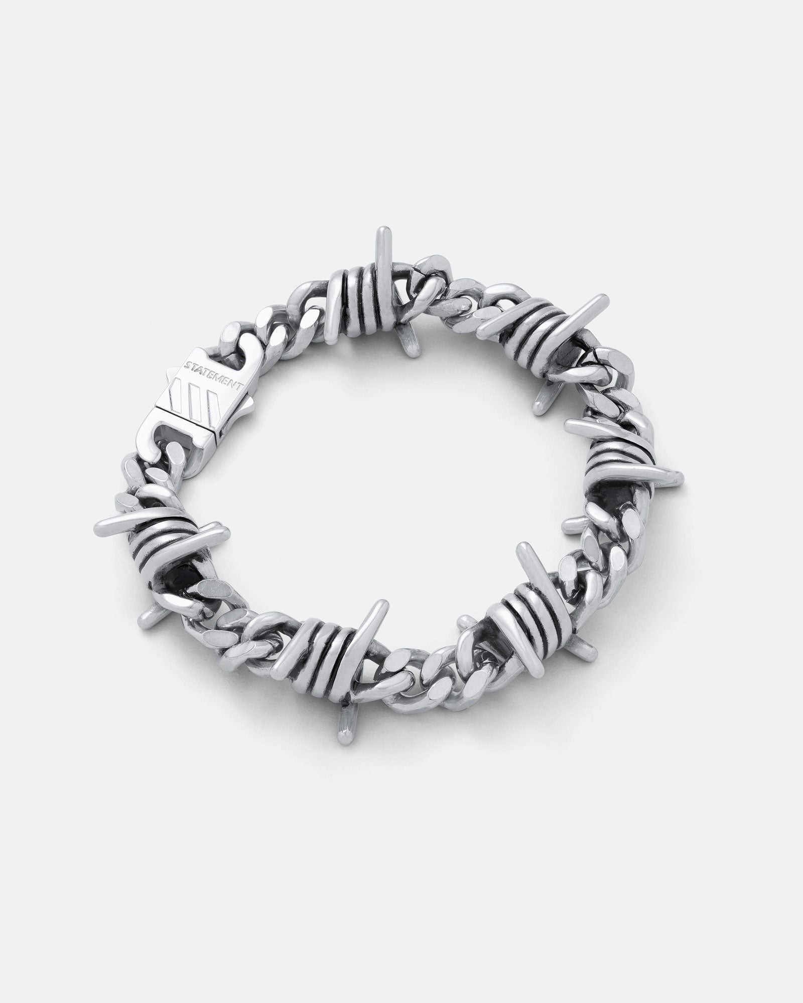 9mm Barbed wire cuban link bracelet in silver on grey background.
